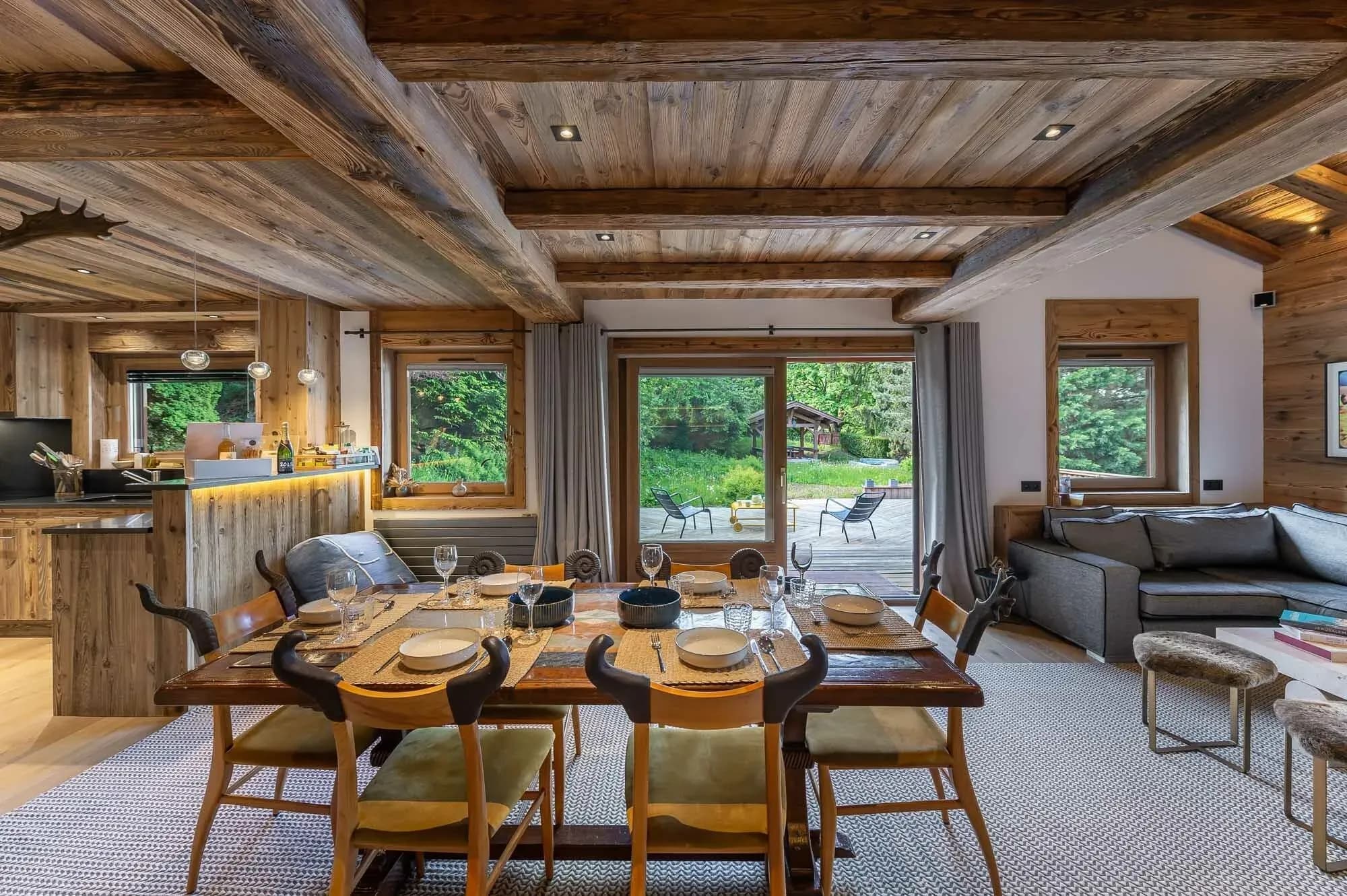 Dining area with wooden table and six chairs, terrace doors beyond