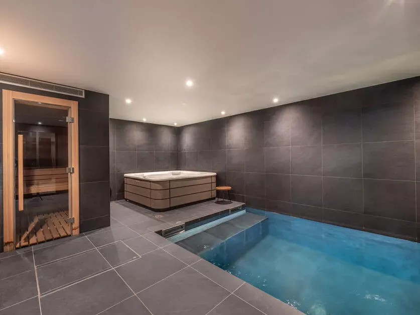 Indoor swimming pool with the sauna beside the wellness area