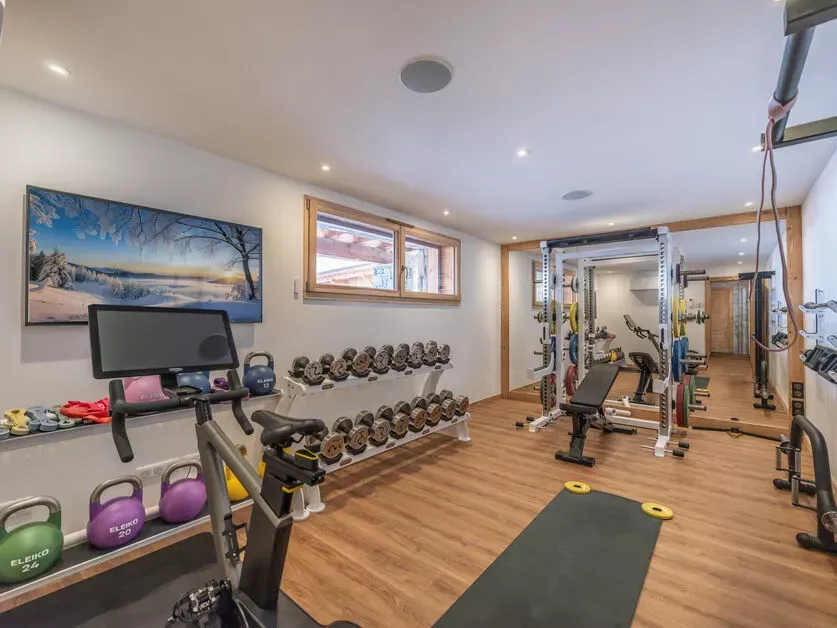 Private fitness room with free weights and strength equipment