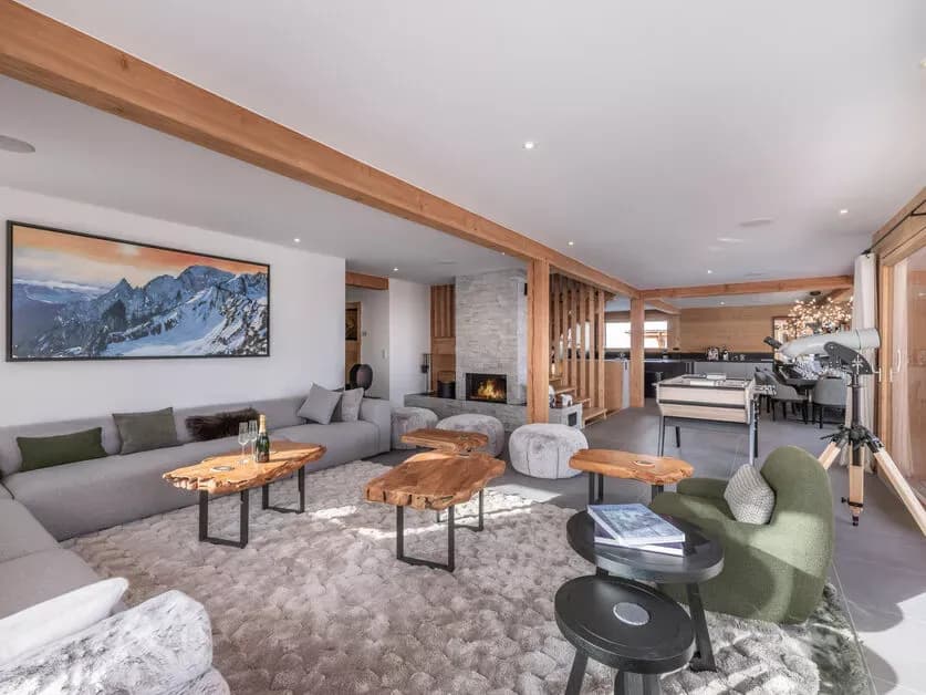 Open-plan living room with panoramic windows and timber beams