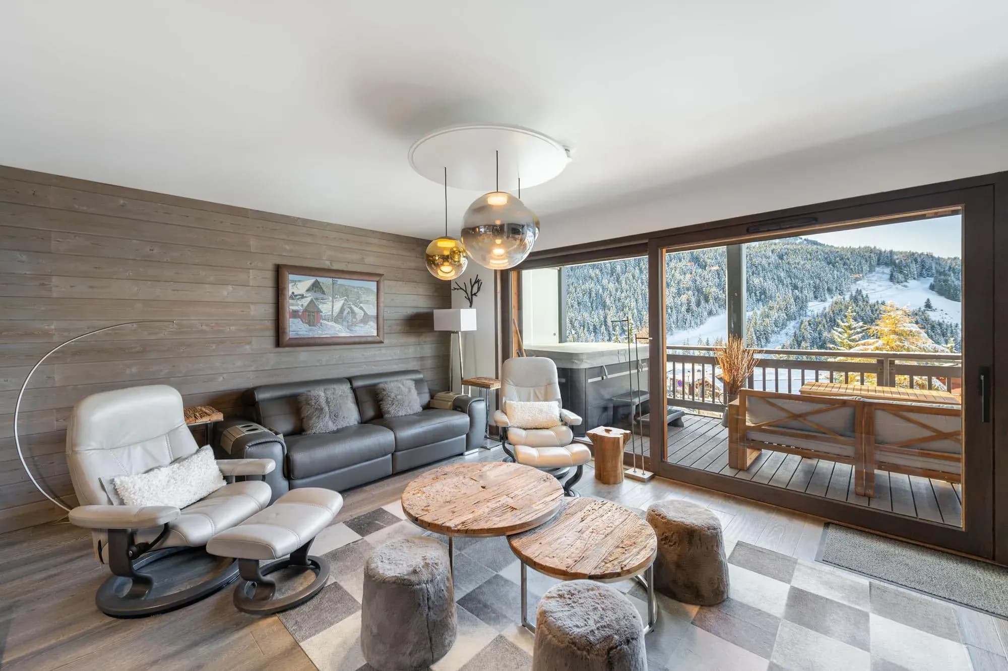 Living room with leather sofa, two recliners and sliding doors to the balcony
