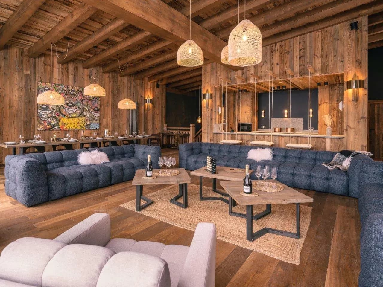 Living room with two blue sofas, coffee tables and long dining table behind