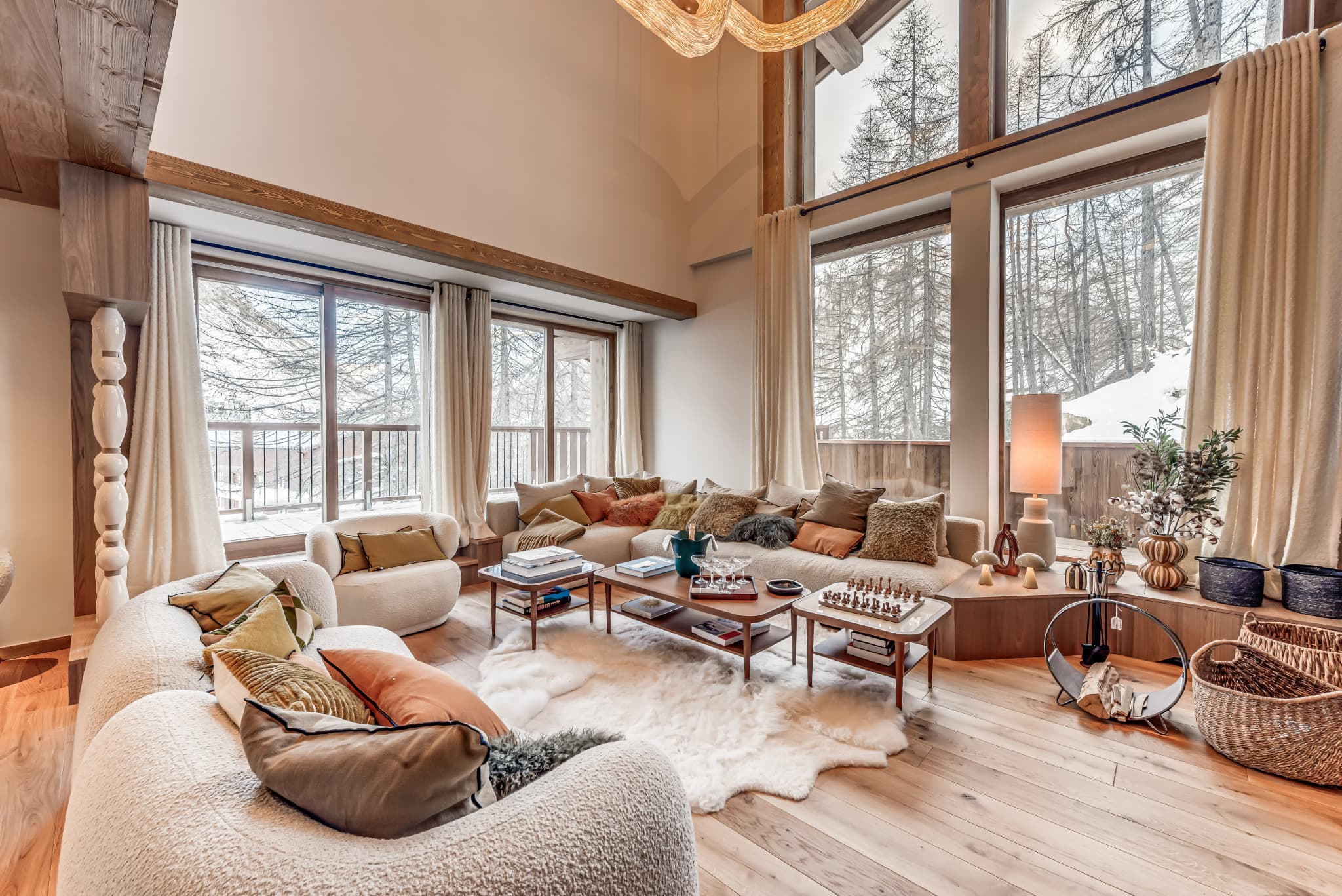 Double-height lounge with mountain-facing windows