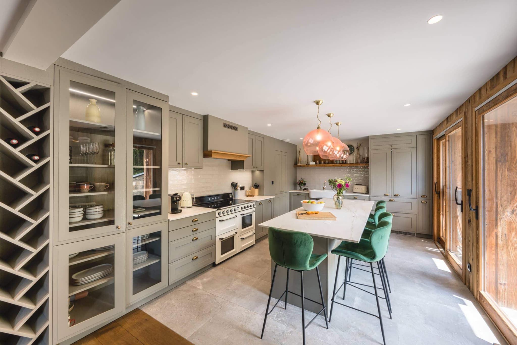 Country-style kitchen with central island, double oven and six bar stools