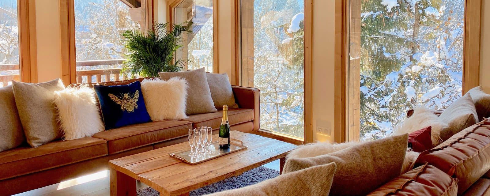 Top-floor lounge with two sofas and snowy forest views