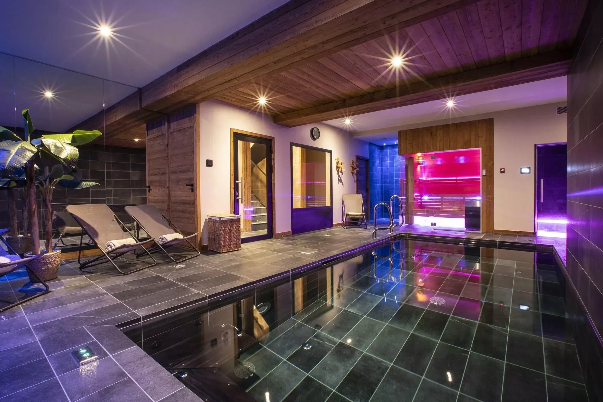 Private indoor pool and wellness area with coloured lighting