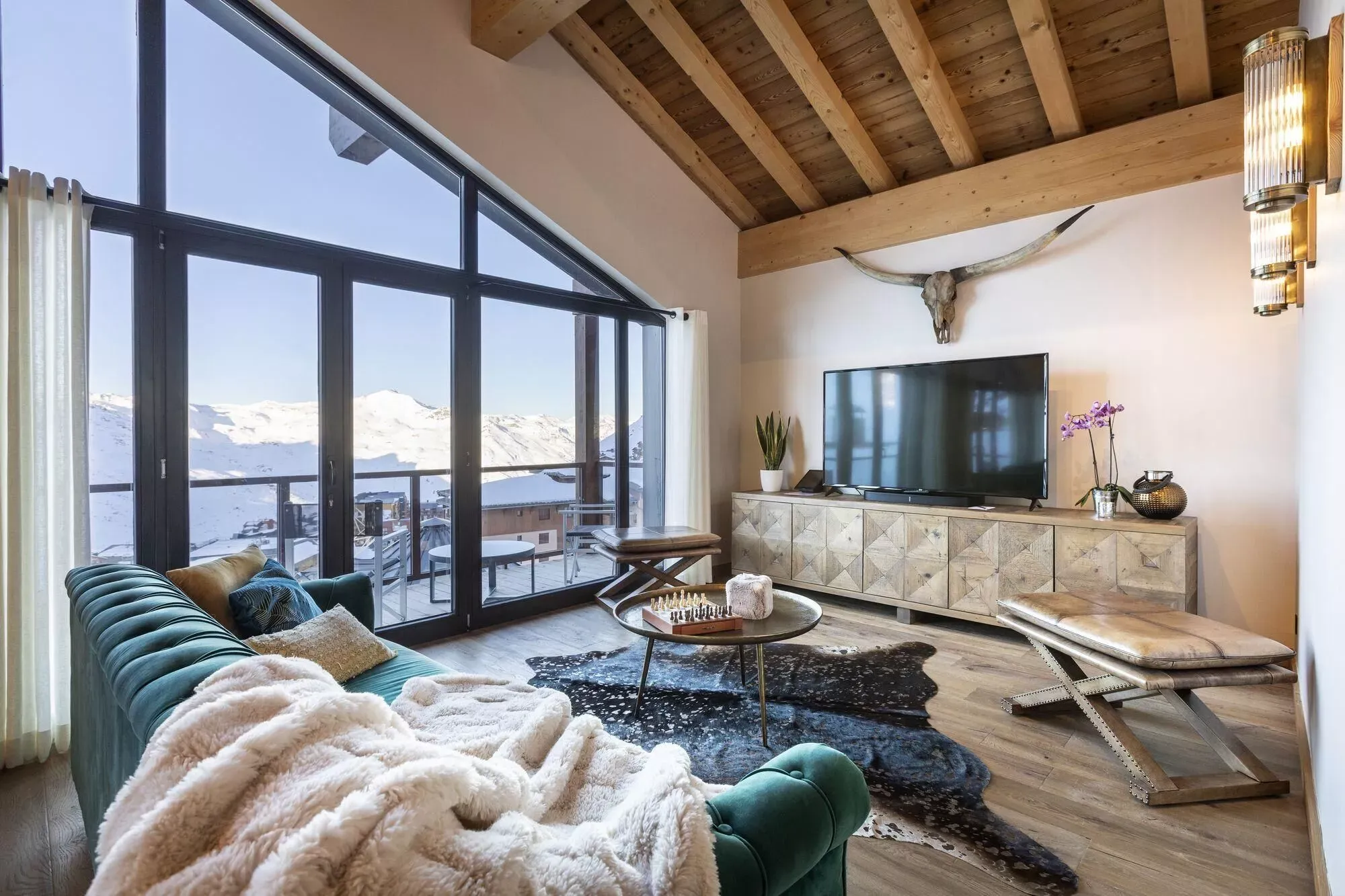 Living room with timber ceilings and mountain-facing windows