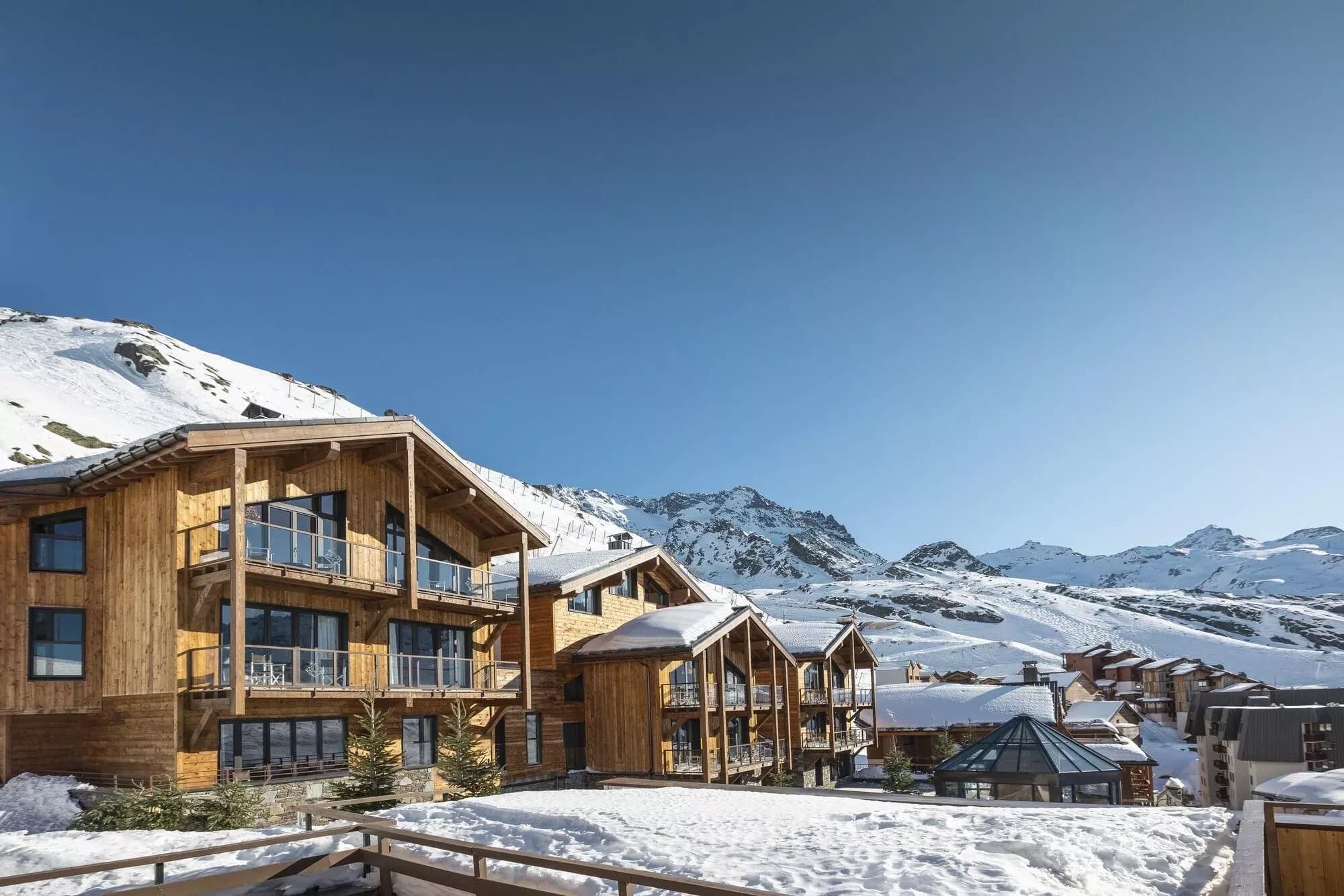 Snow-covered chalet buildings with balconies