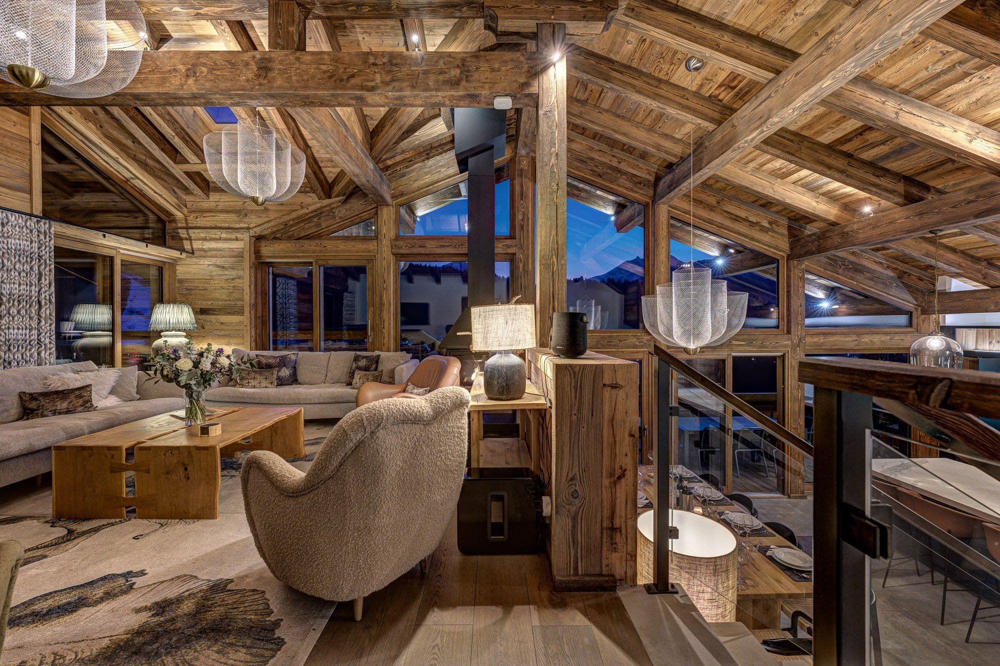 Open-plan living room with exposed timber beams and panoramic mountain views