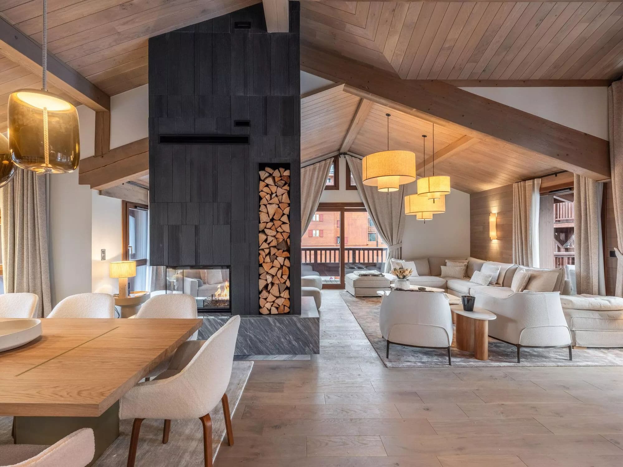 Open-plan lounge and dining room beneath a vaulted timber ceiling