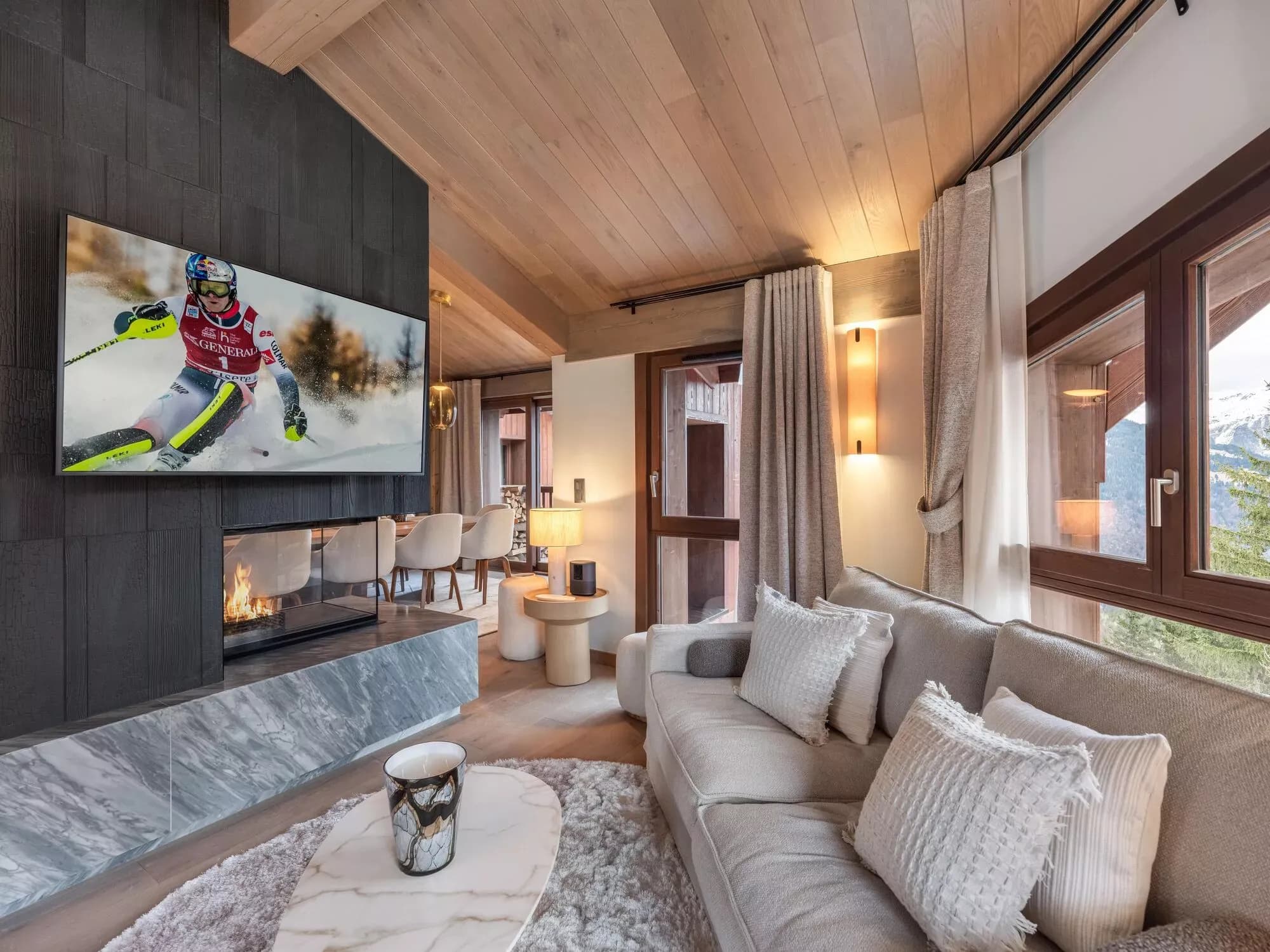 Television lounge beside the wood fireplace and balcony doors
