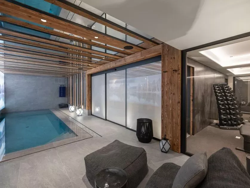 Indoor swimming pool beside the sauna and staircase