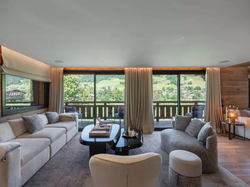 Living room with sofas and windows opening to the terrace