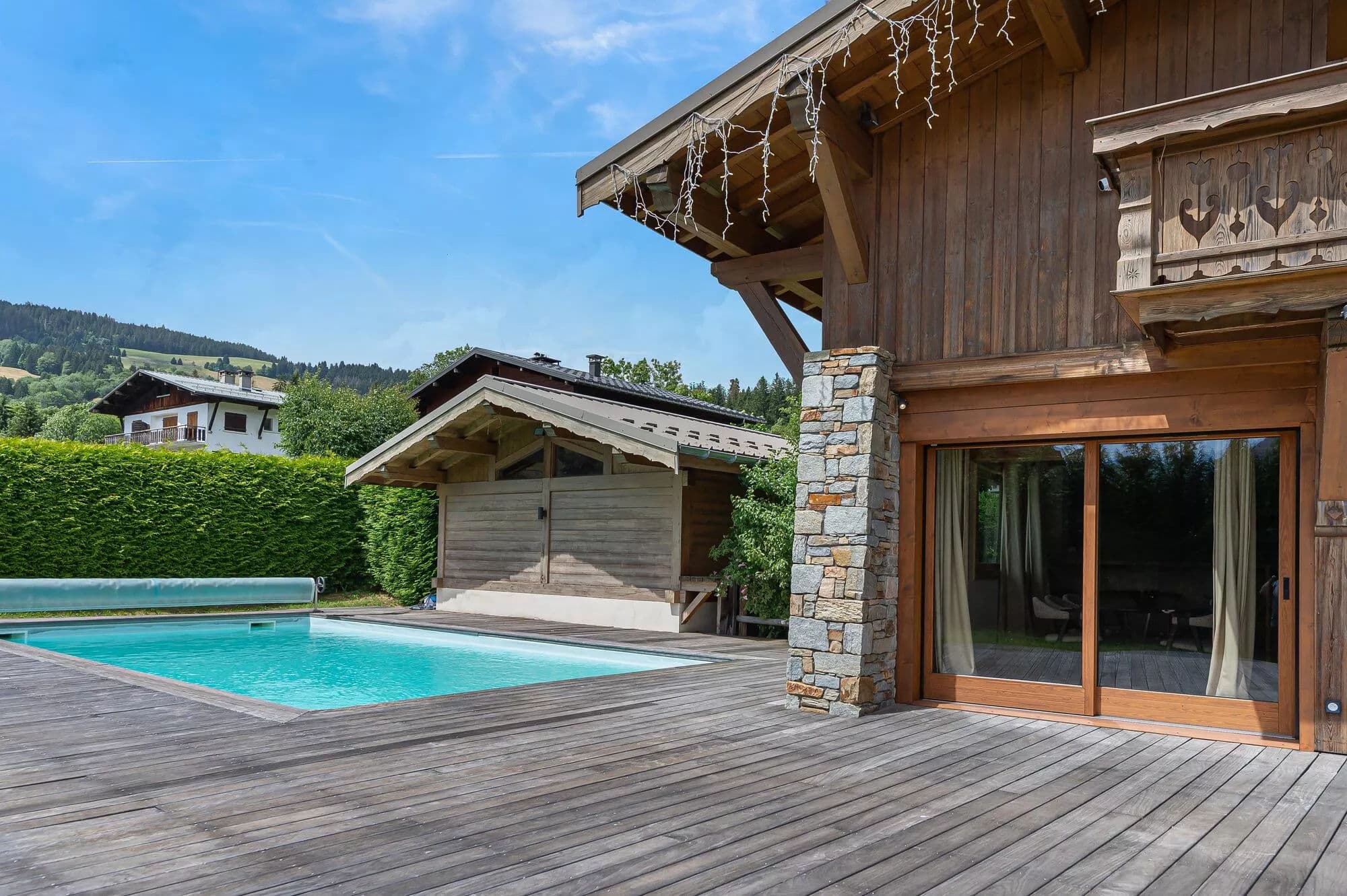 Chalet terrace beside the heated outdoor swimming pool
