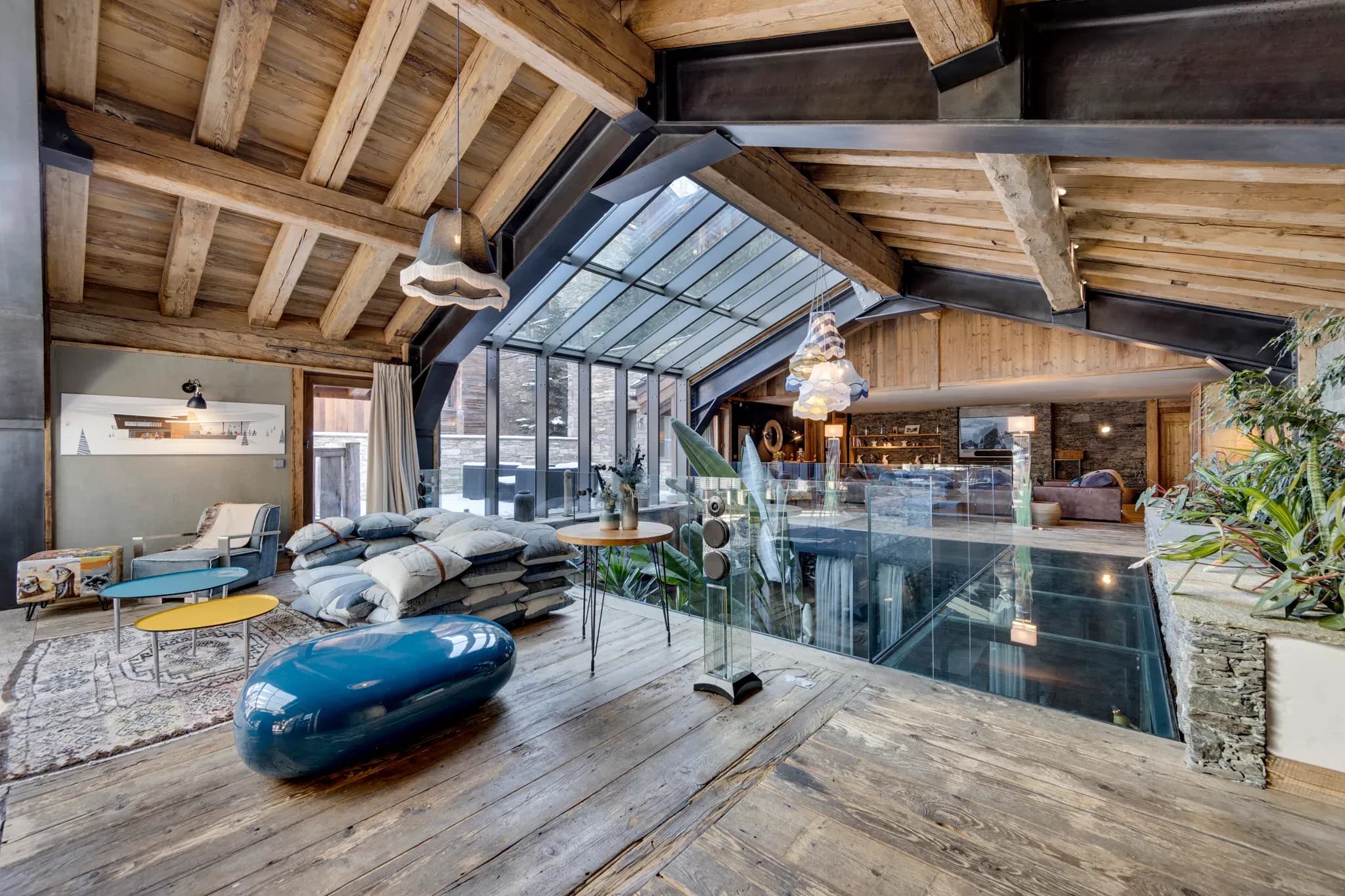 Mezzanine lounge with glass floor panel, glazed roof and floor cushions
