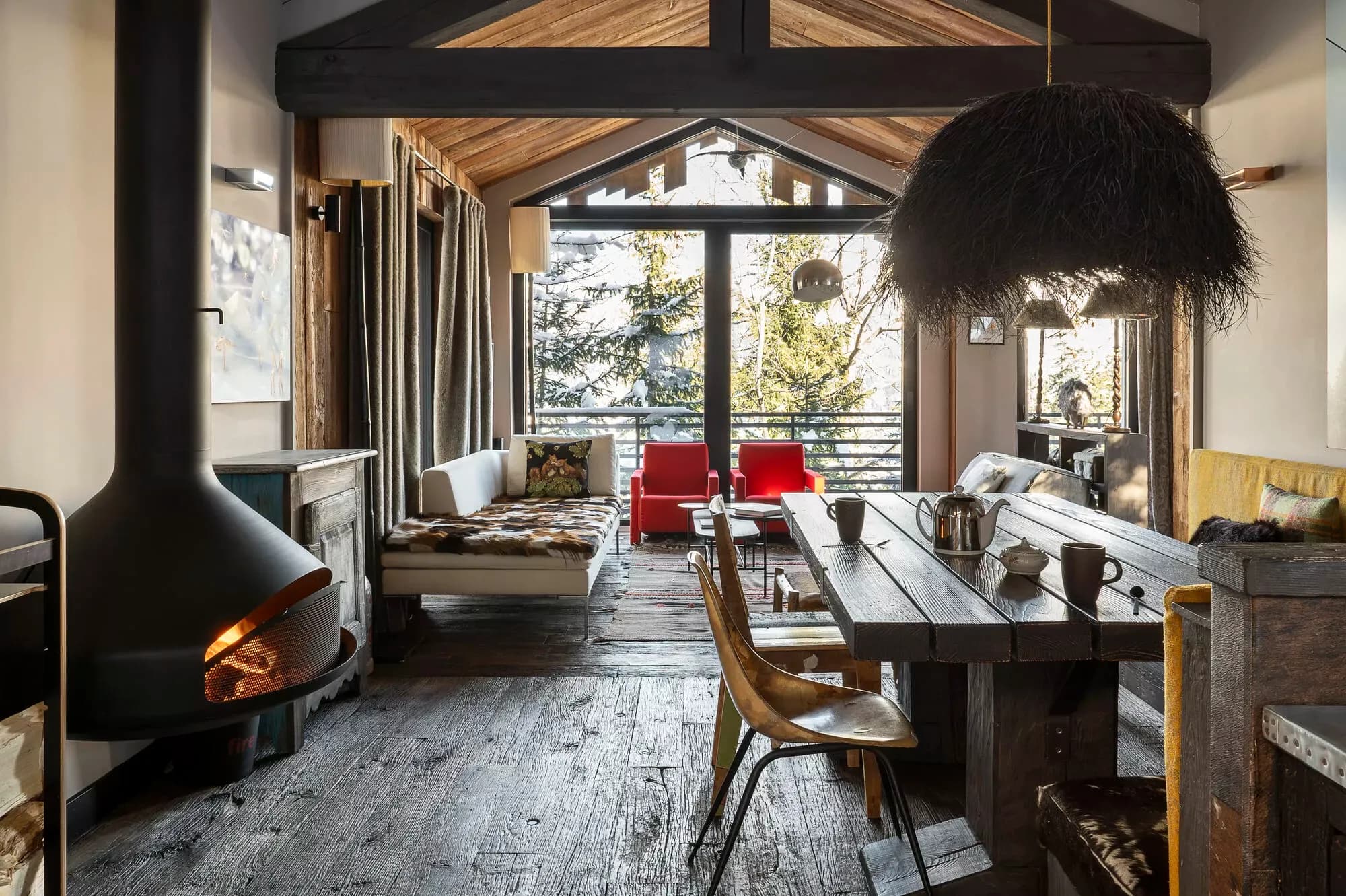 Open-plan living and dining room with a suspended wood fireplace