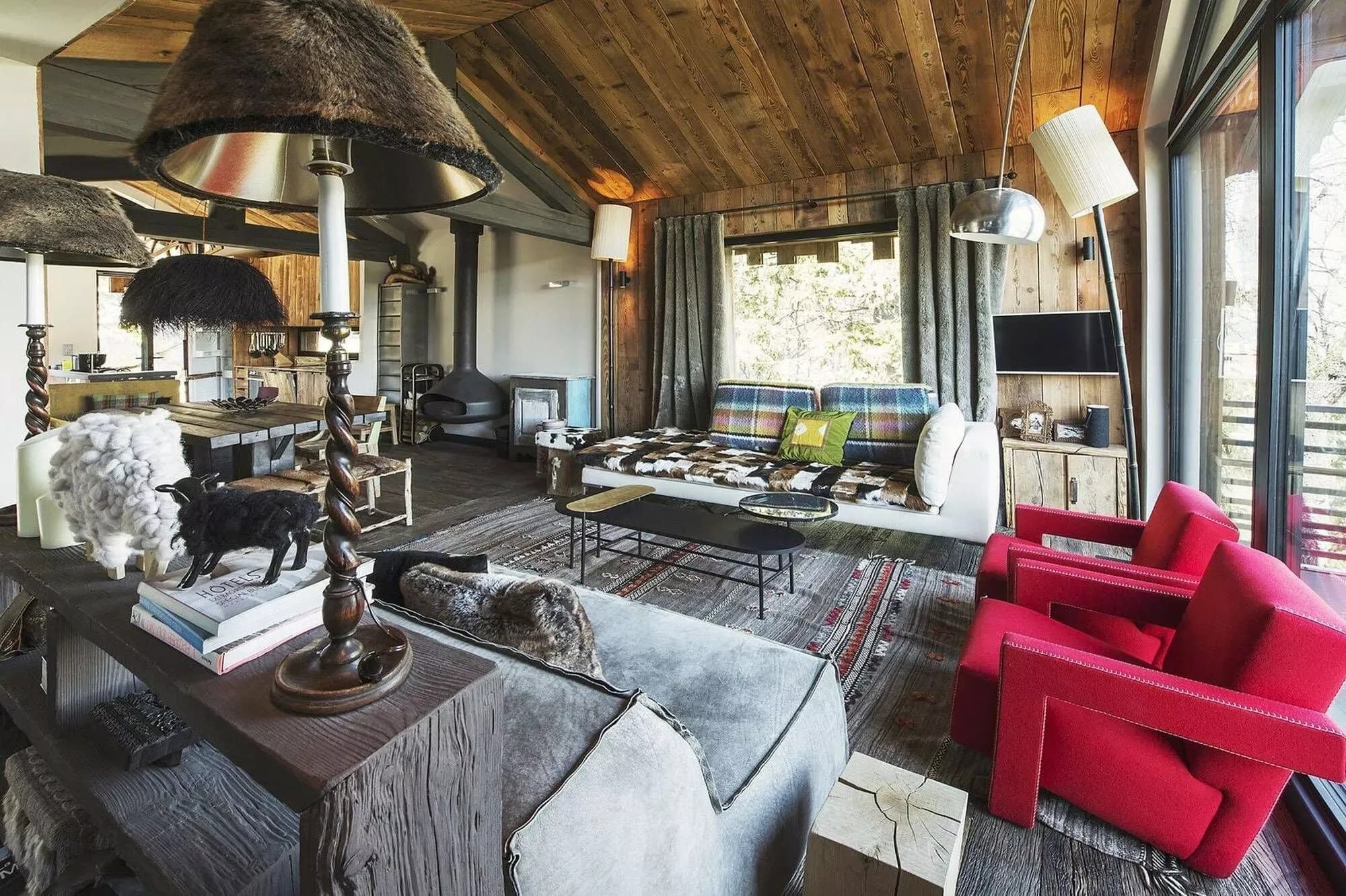 Living room with sofas, red armchairs and mountain views