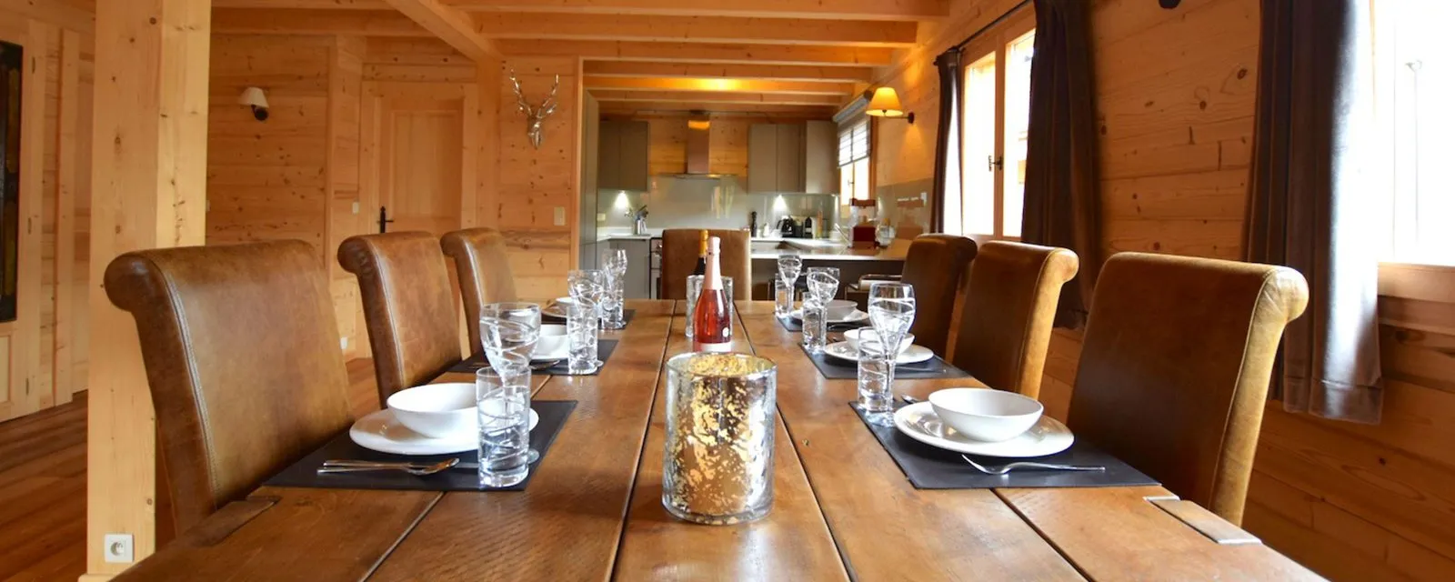 Solid-wood dining table set for eight guests beside the kitchen