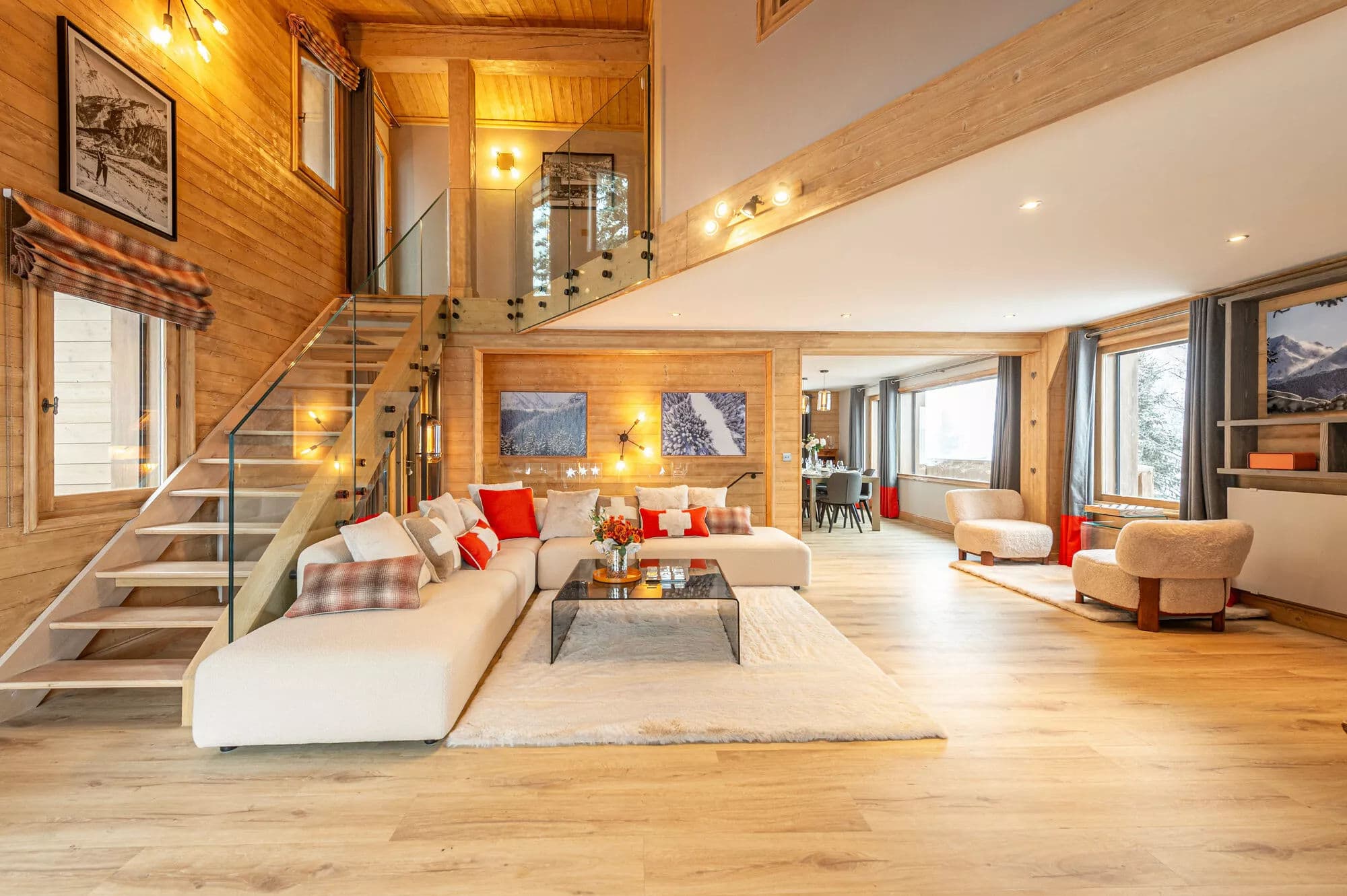 Open-plan living room with fireplace, lounge seating and staircase to the upper floor