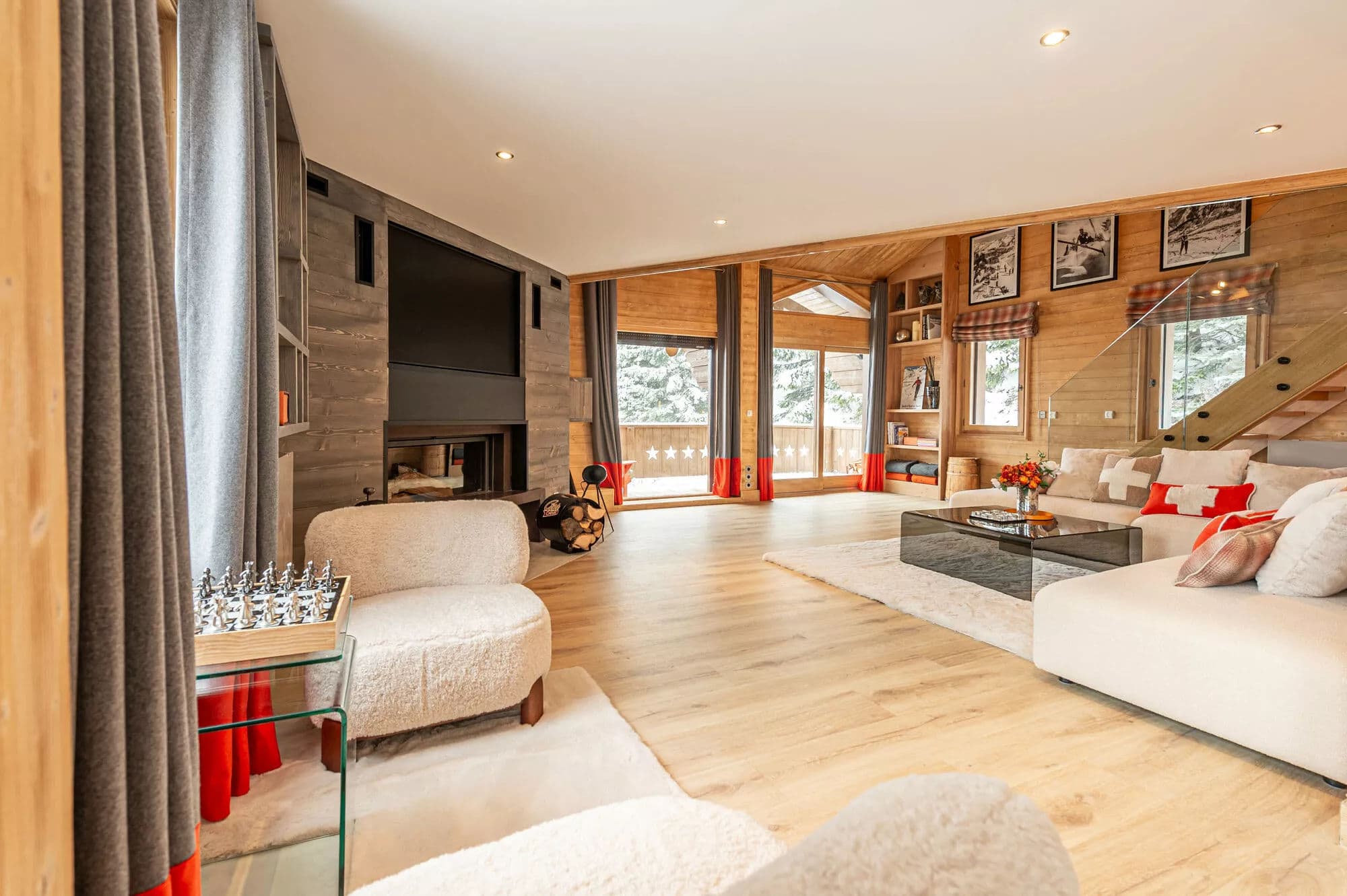 Living room with fireplace, sectional sofas and large windows