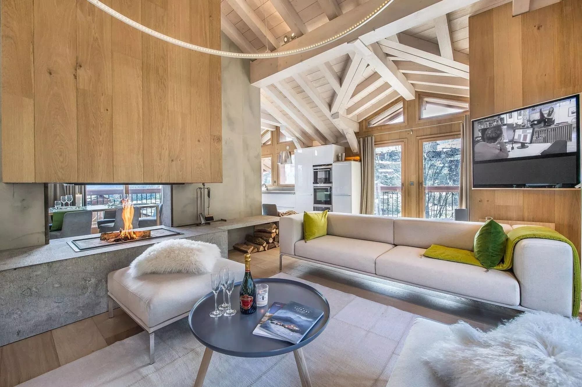 Central wood fireplace between the chalet living and dining areas