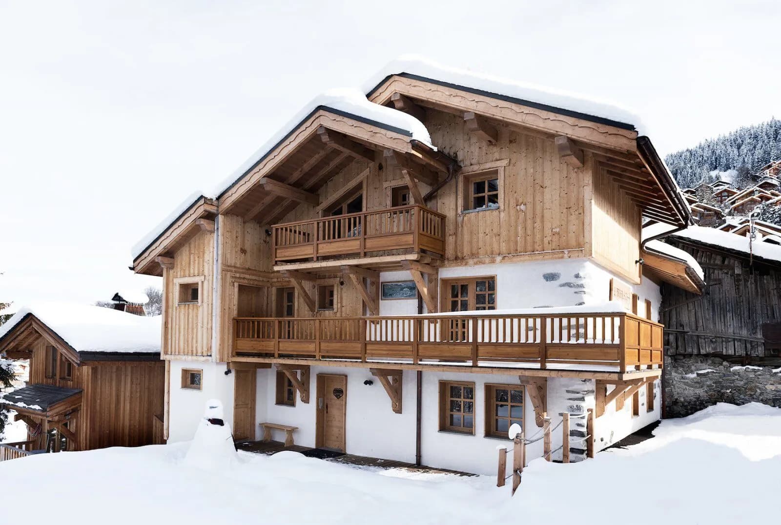 Snow-covered timber chalet with balconies