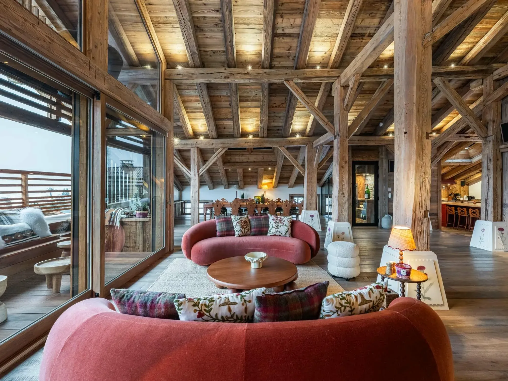 Living room with two curved sofas, round coffee table and exposed timber beams