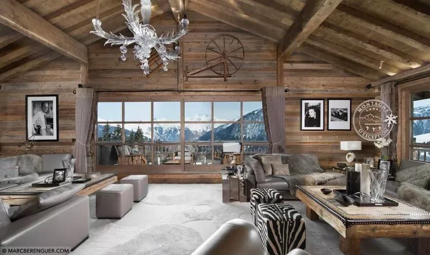 Living room with timber beams, panoramic windows and mountain views