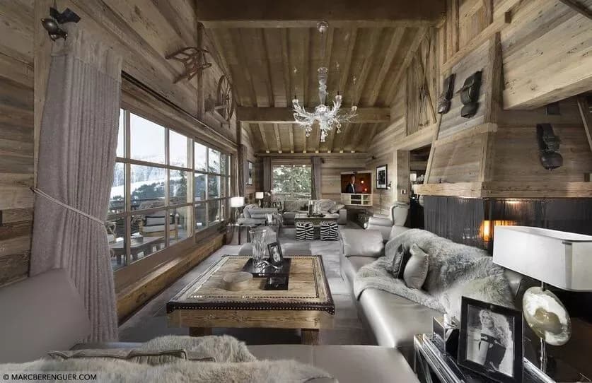 Fireside living area opening to a balcony with mountain views