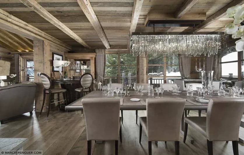 Dining area with chandelier beside the open-plan living room