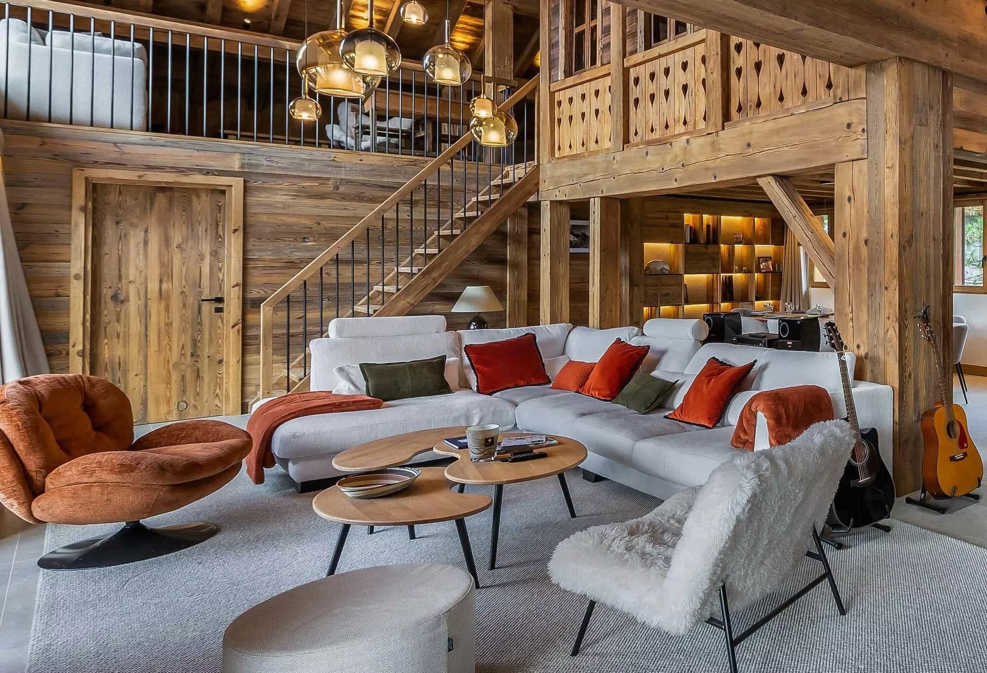 Double-height living room with a central fireplace and gallery walkway