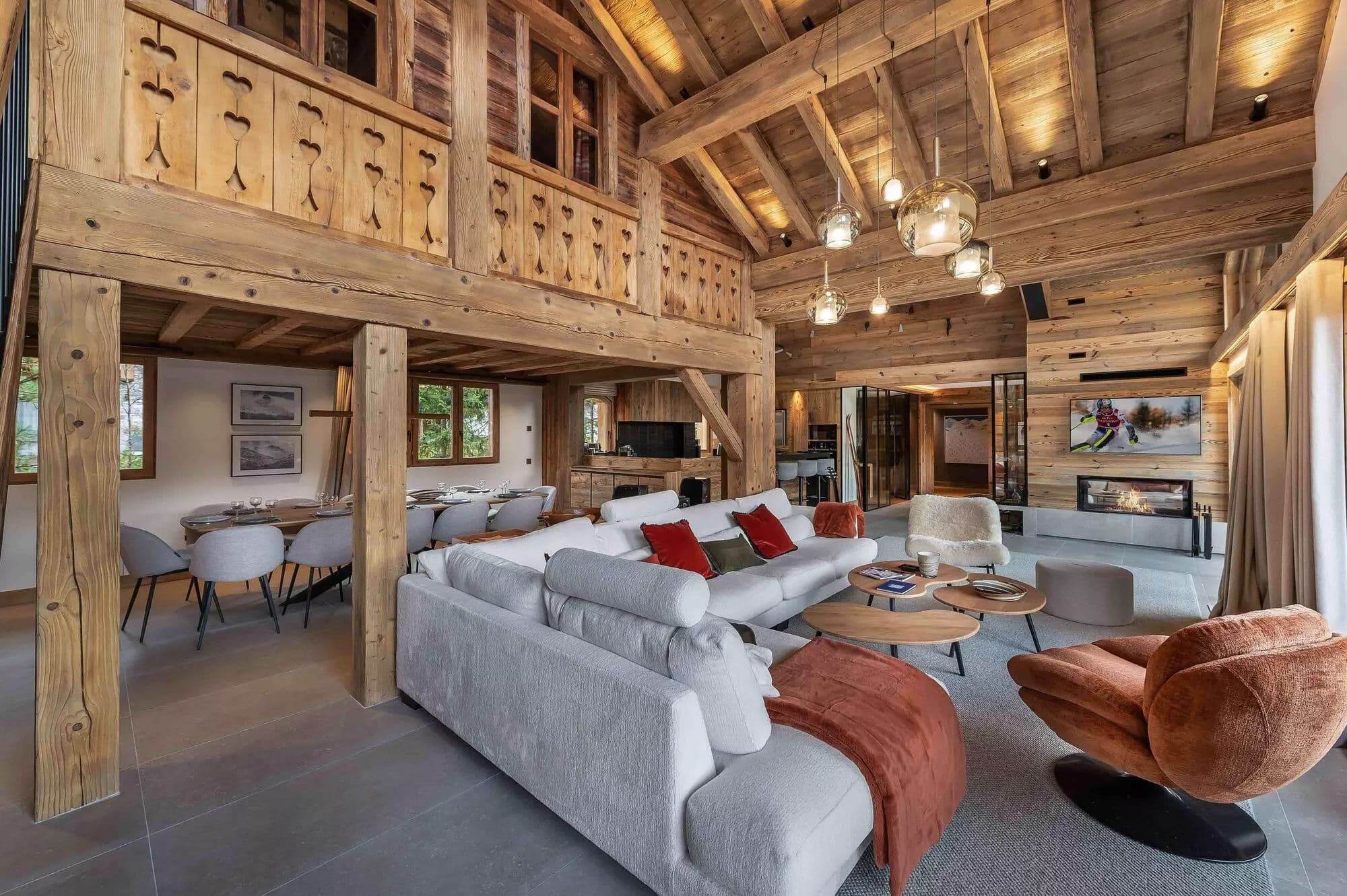 Open-plan living room with timber beams and kitchen beyond