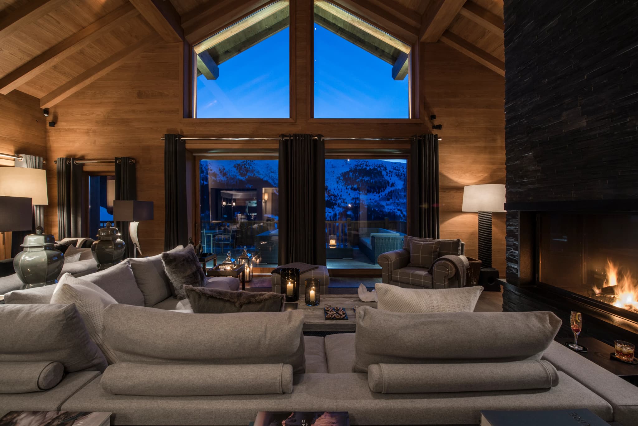 Lounge with triple-height windows and fireplace