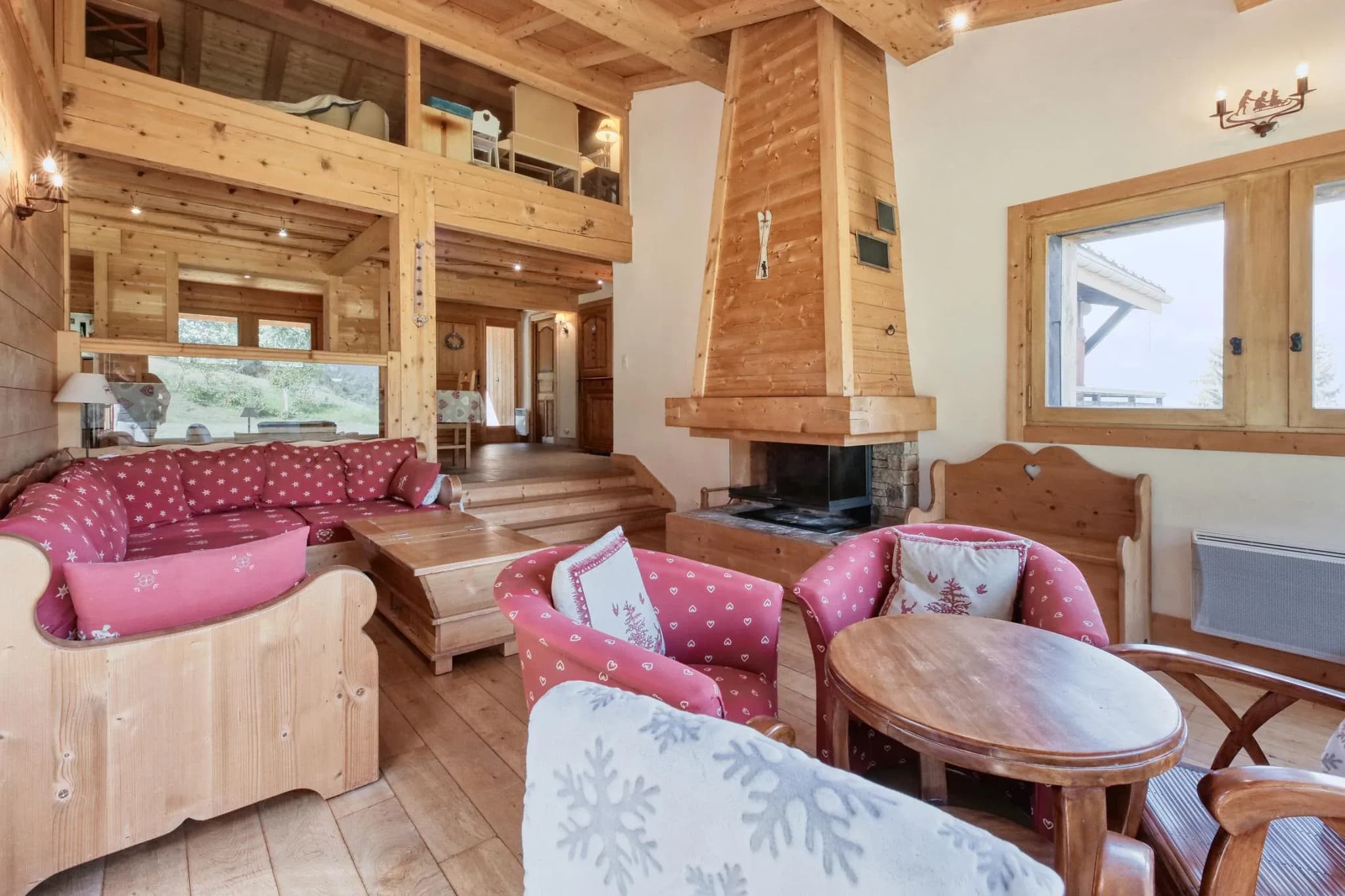 Living room with corner sofa, open fireplace and two armchairs