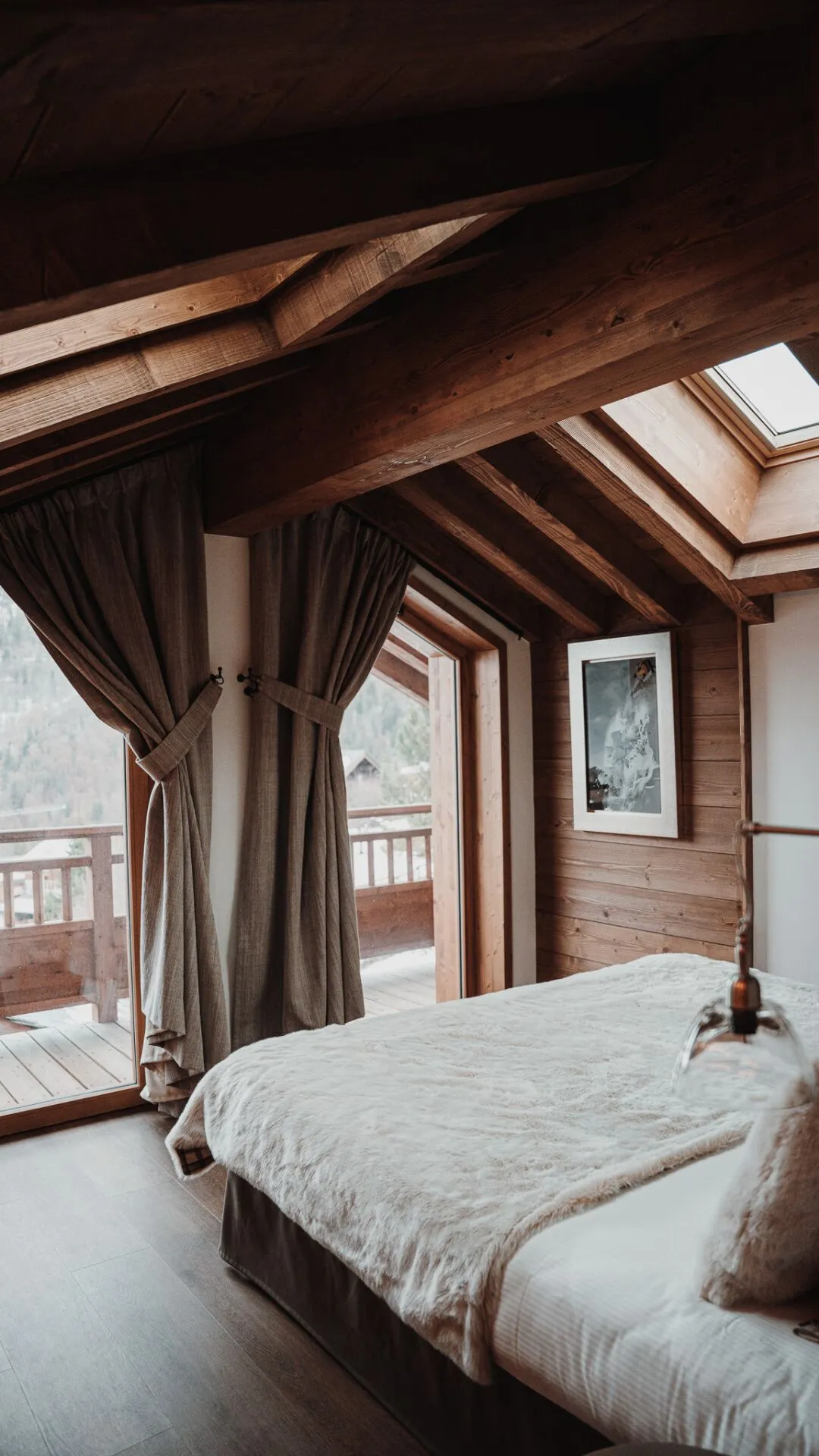 Bedroom with timber beams and a window