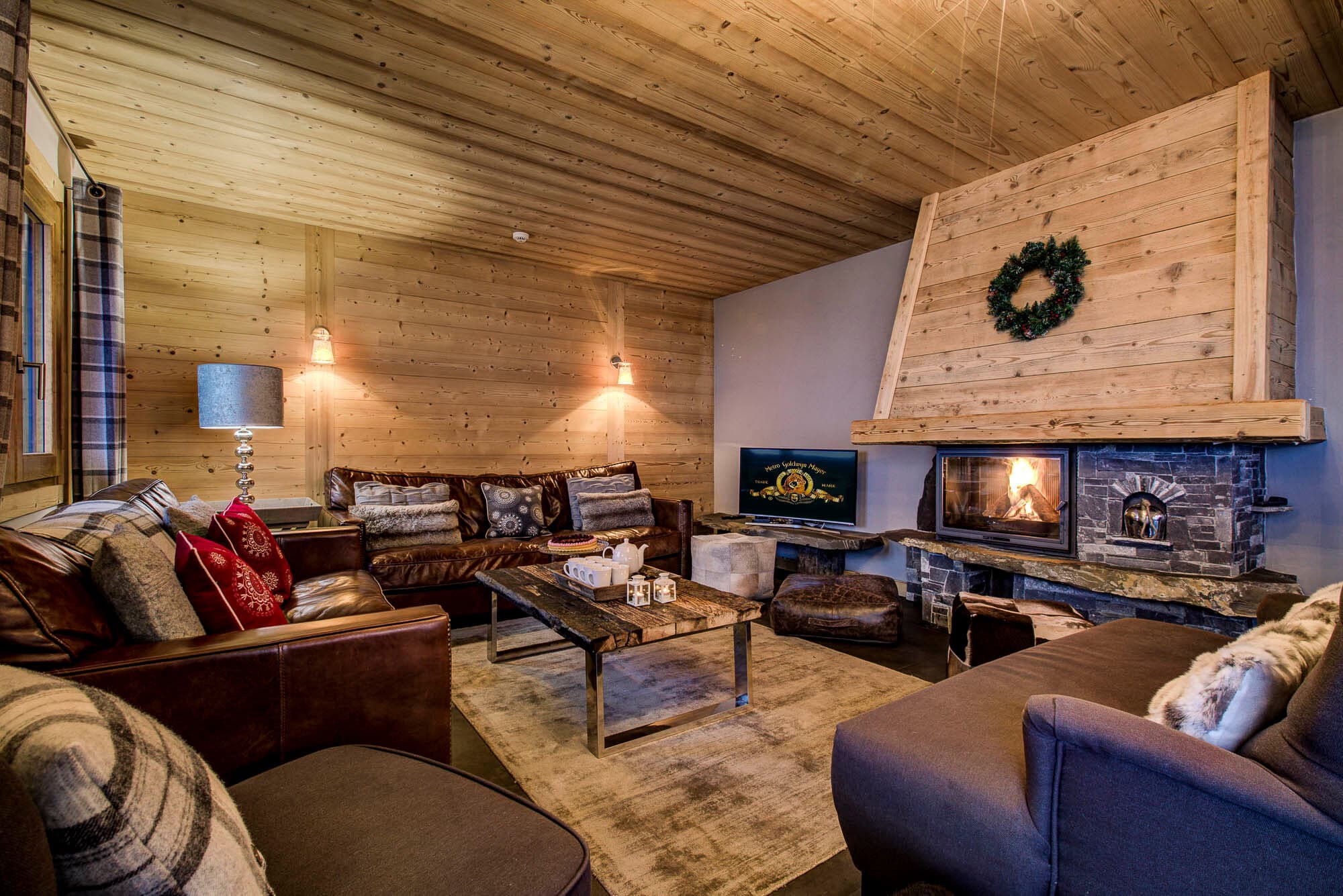 Living room with an open fireplace and leather seating