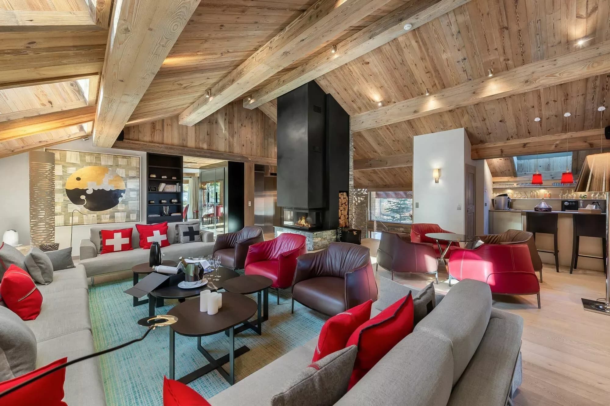 Living room with two seating areas beneath a timber ceiling