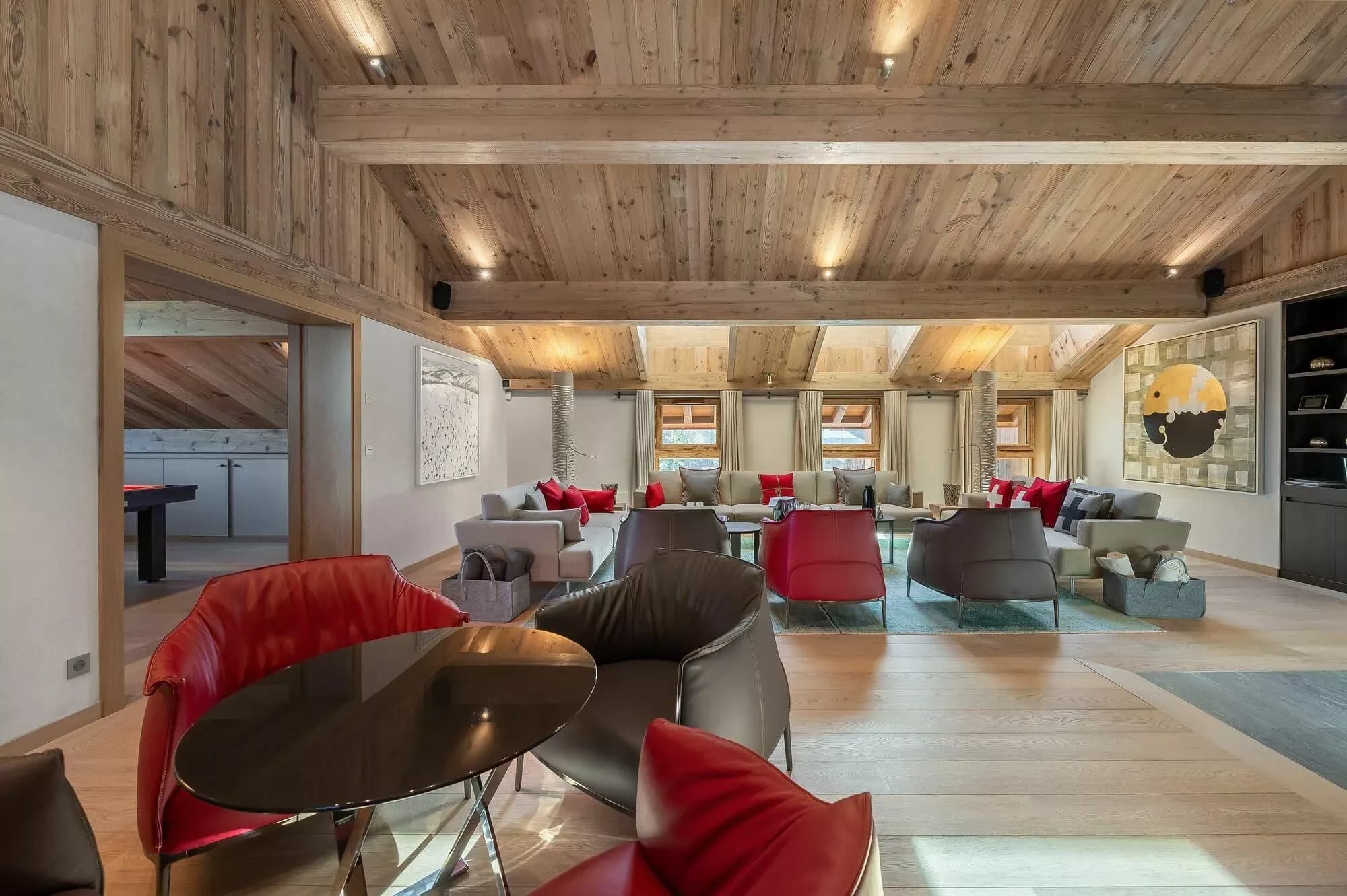 Open-plan living and dining level with red lounge seating