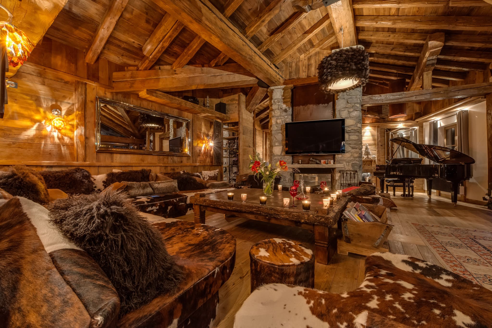 Grand piano and fireplace in the timber-beamed living room