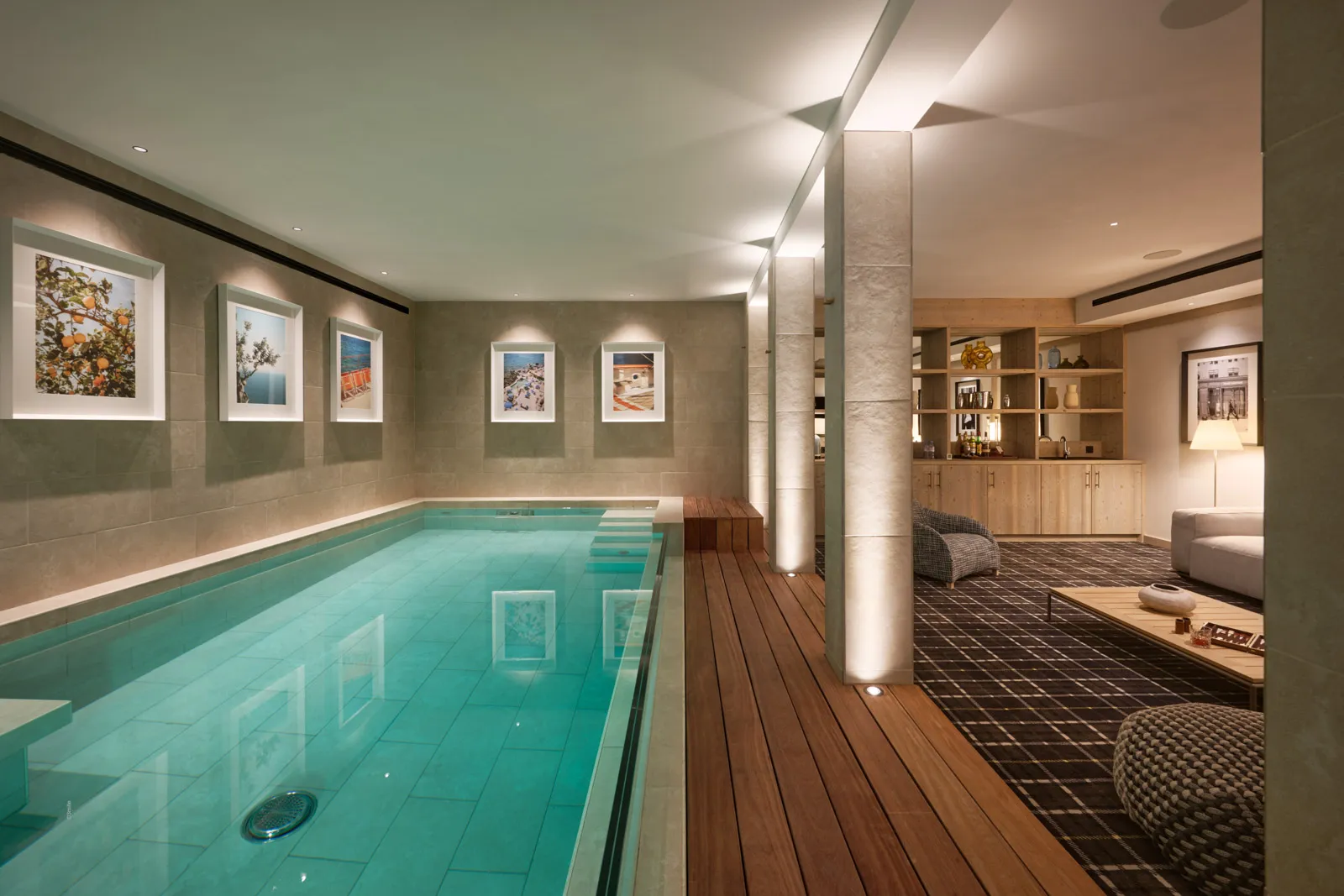 Indoor swimming pool beside a carpeted lounge area