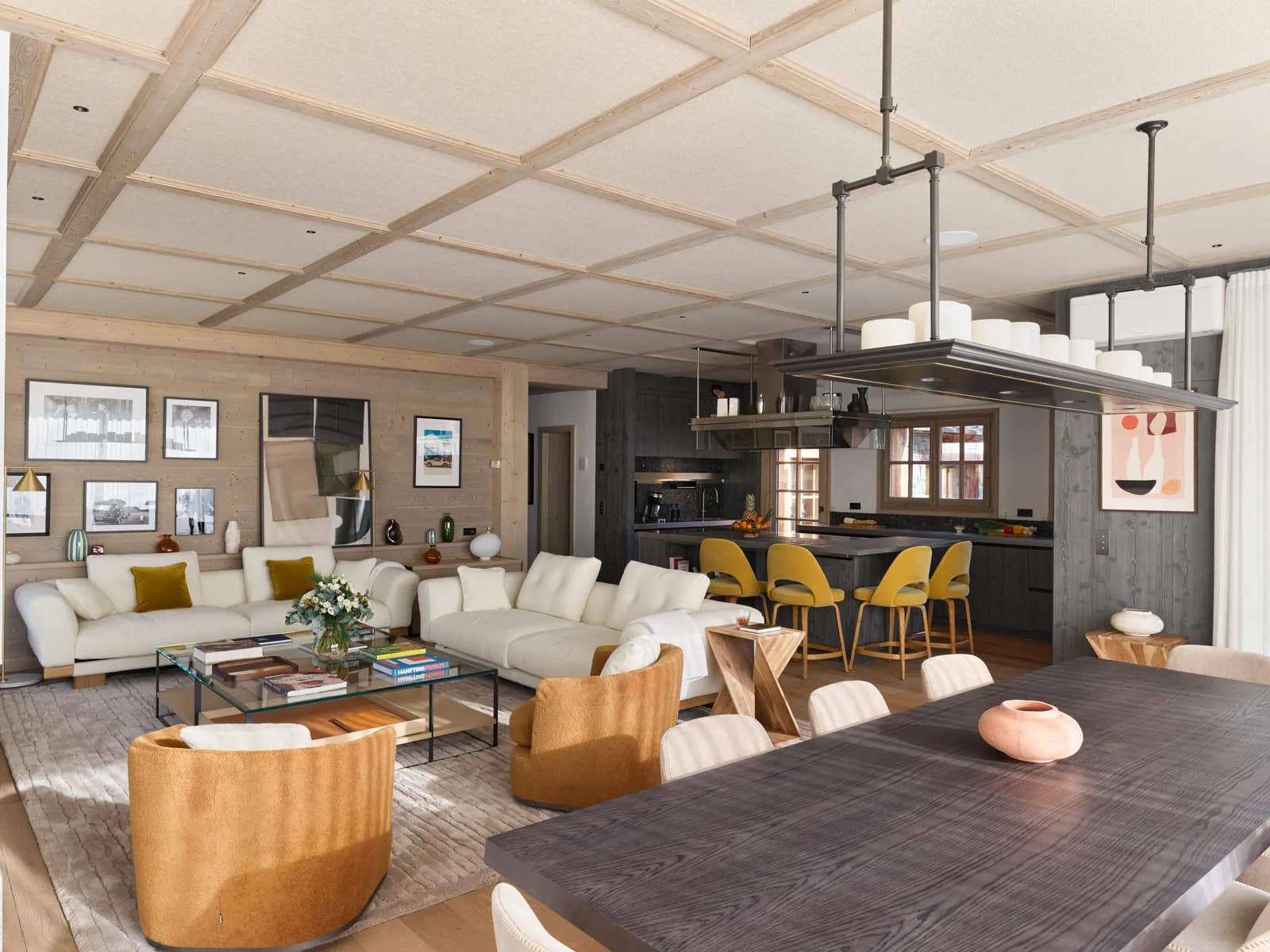 Open-plan living, dining and kitchen area with wood-panelled finishes