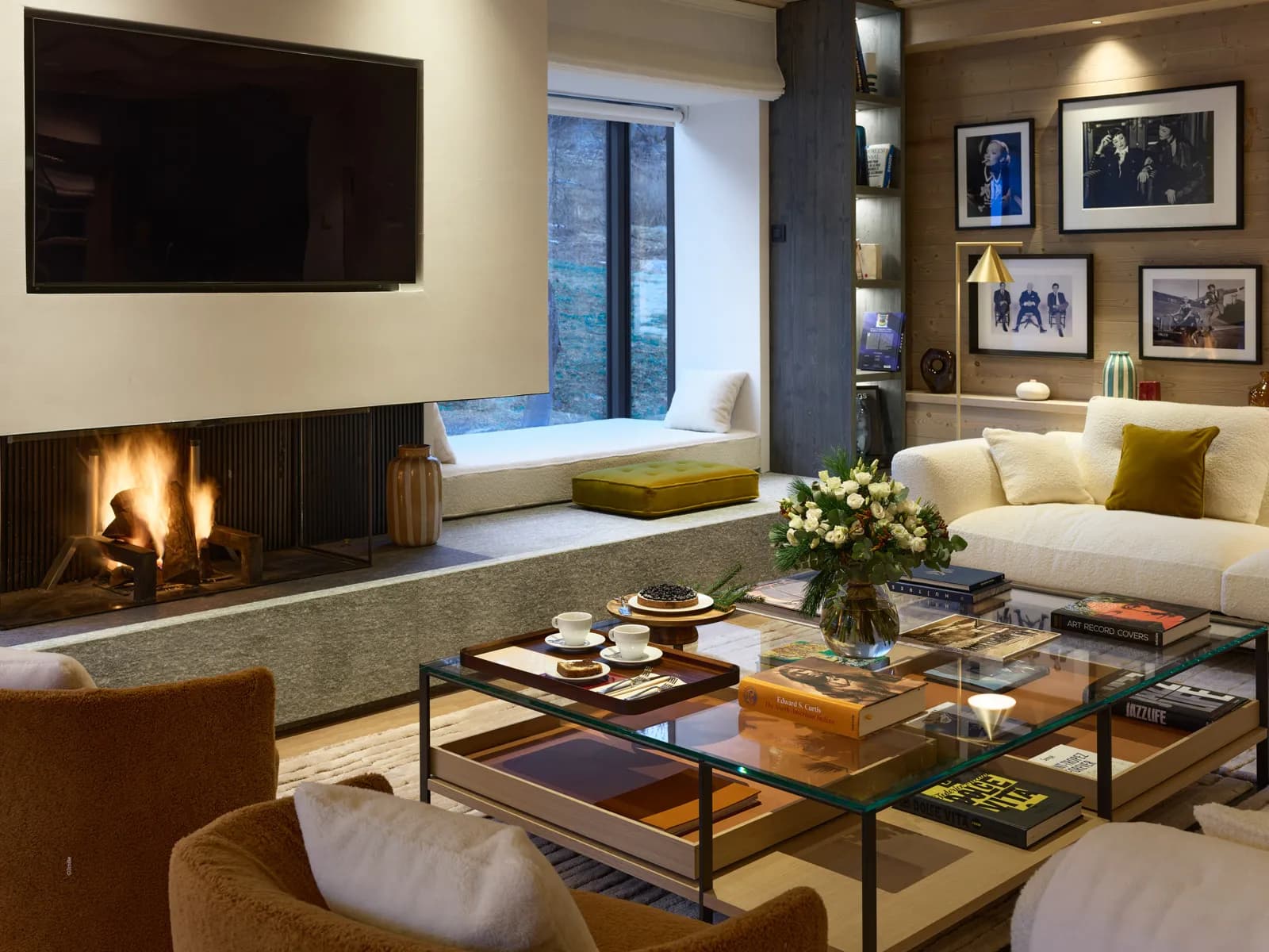 Living room with open fireplace, sofas and window seat