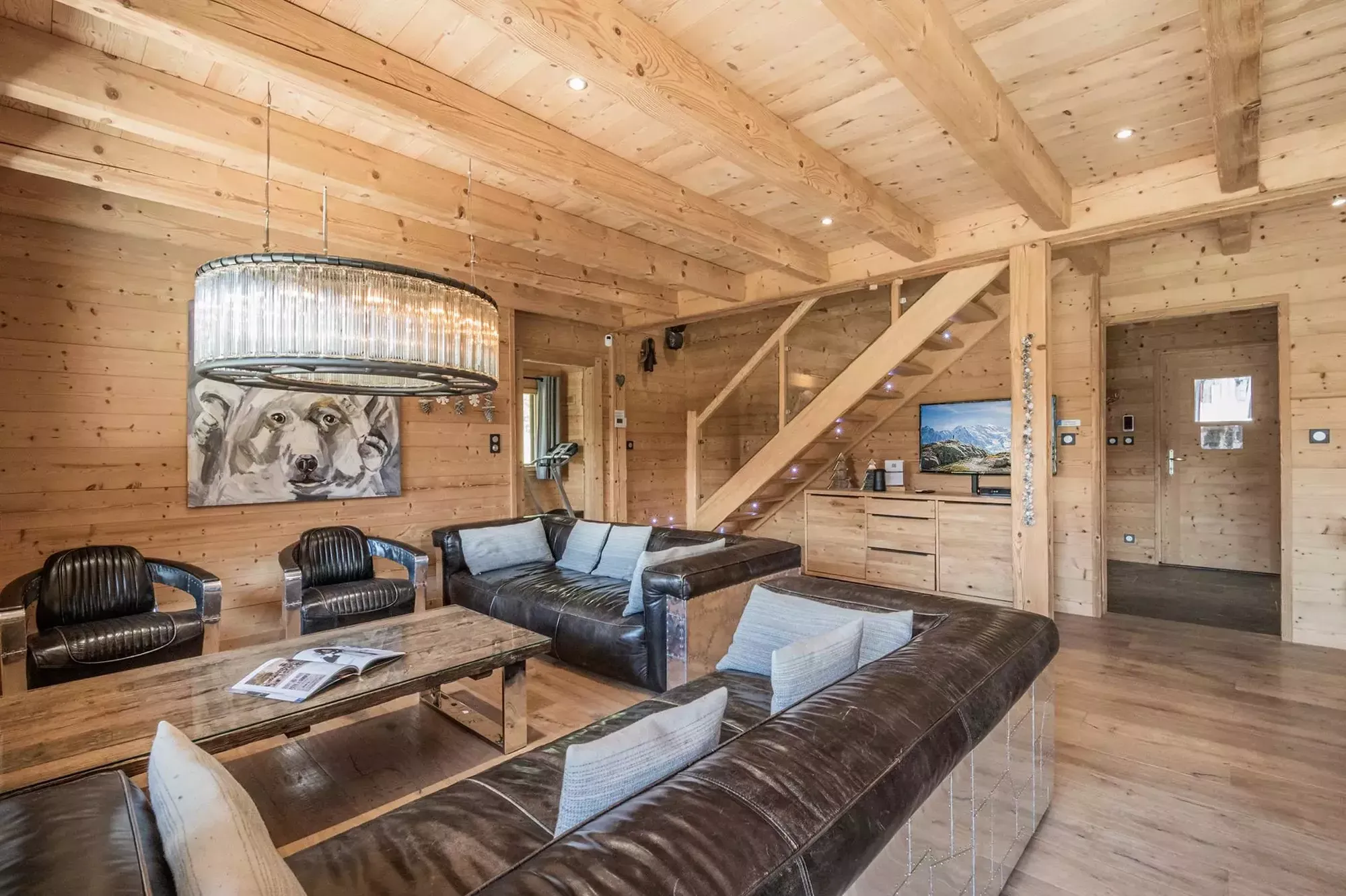Timber lounge with leather seating and an open staircase