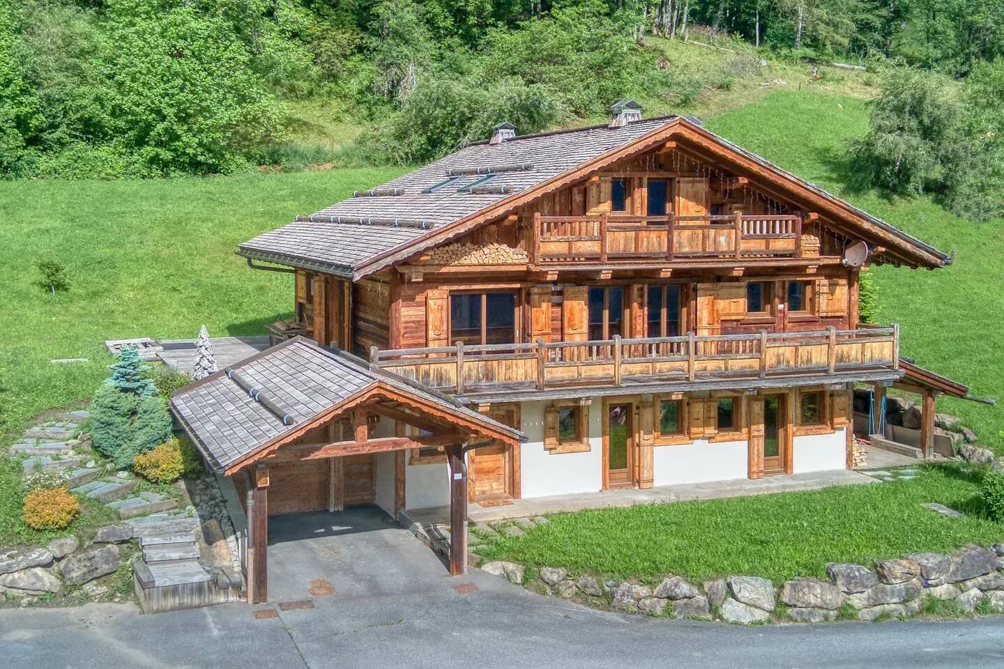 Wooden chalet with two balconies, carport and lawn