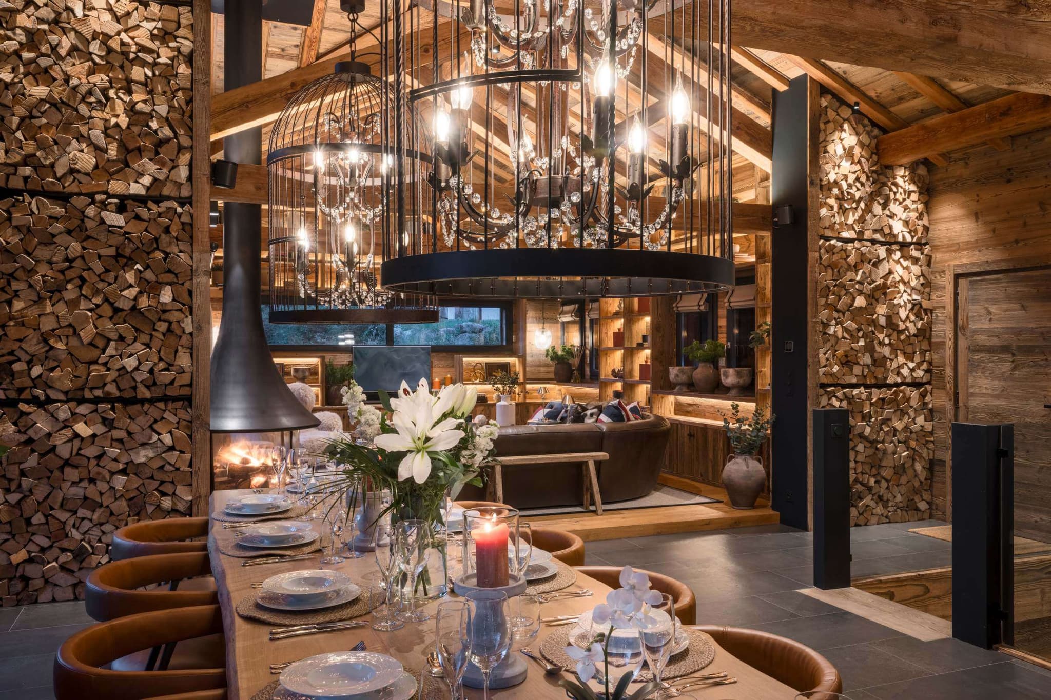 Dining table beside floor-to-ceiling windows and mountain views