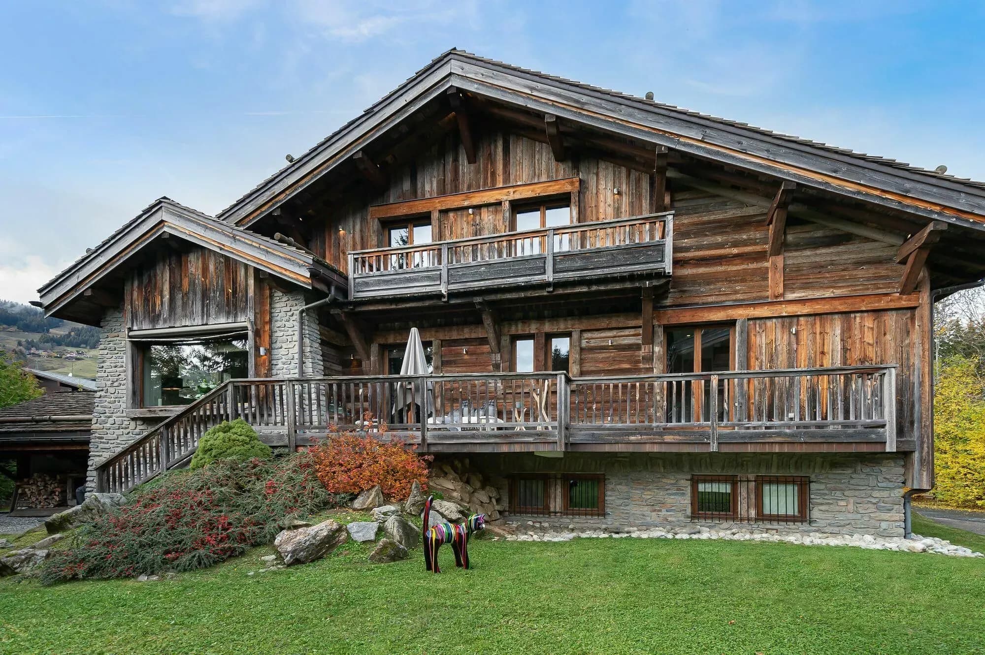 Timber chalet exterior with balconies and landscaped lawn