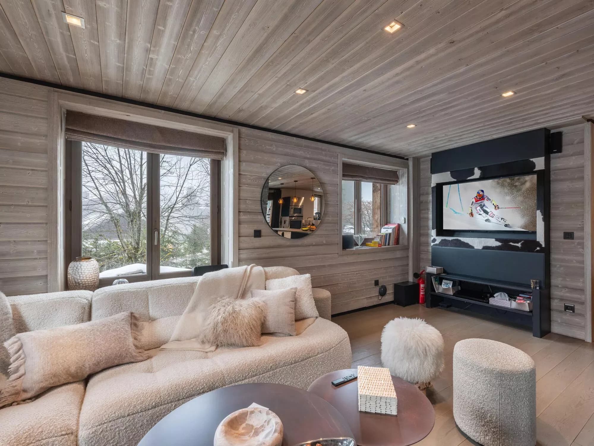 Living room with sofas, round coffee table and television