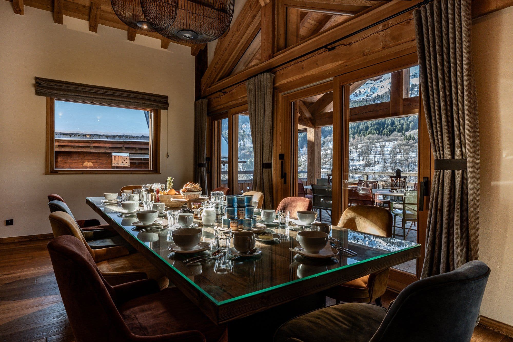 Dining room seats 8; floor-to-ceiling windows frame mountain views