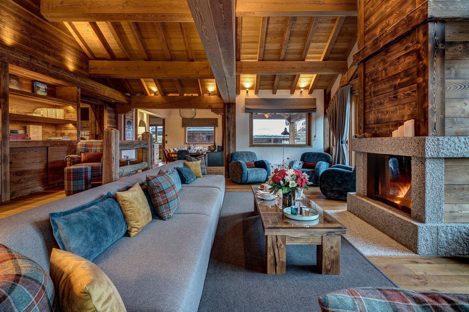 Open-plan living room with dual seating areas, fireplace, and lake views
