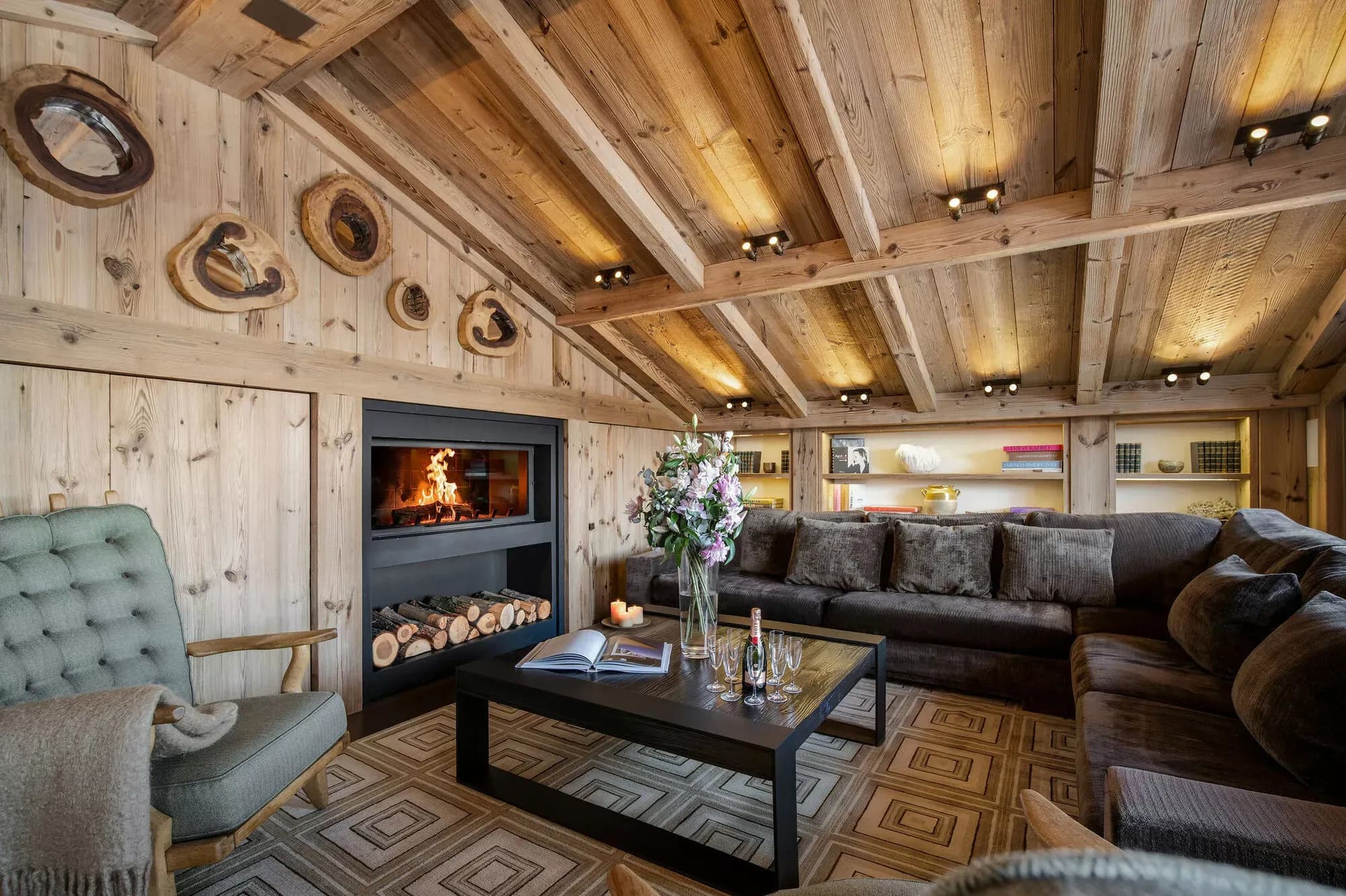 Living room with sectional seating, a wood-burning fireplace and mountain views
